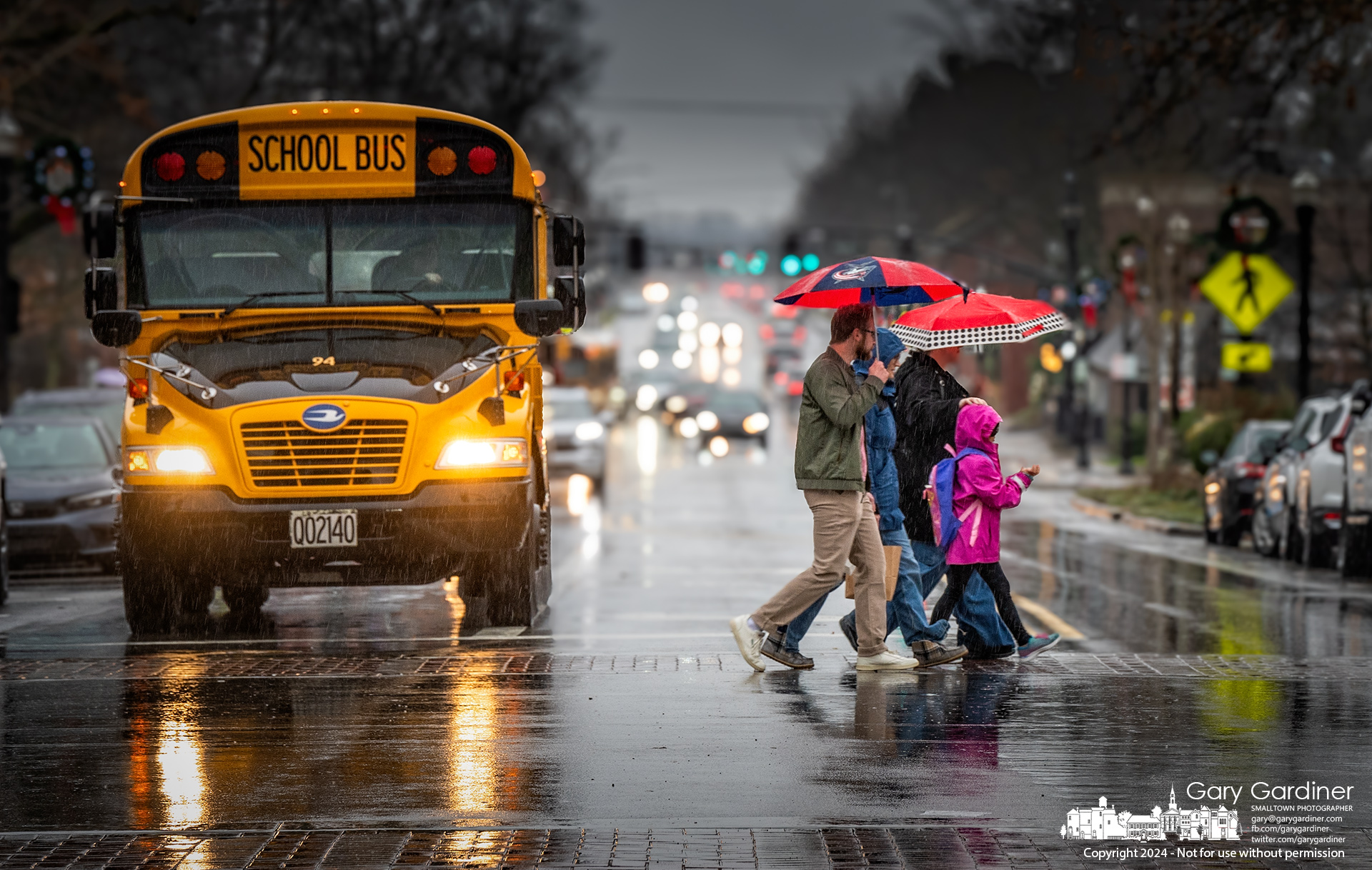 A family walks across State Street, quickly attempting to escape the afternoon rain. My Final Photo for December 16, 2024.