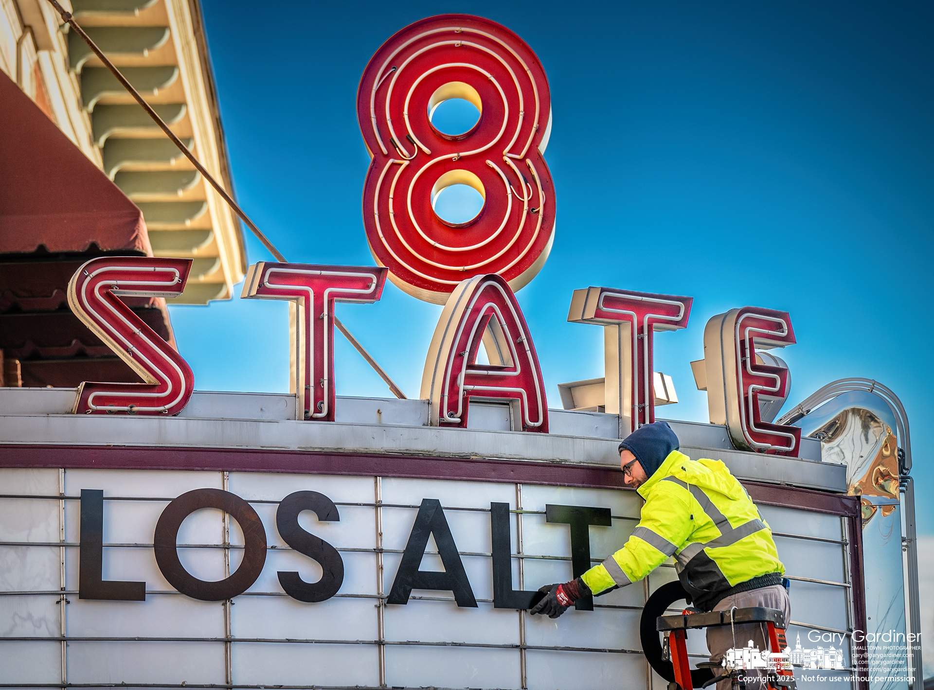 A worker installs new letters onto the marquee at 8 North Street, marking it as Los Altos Mexican restaurant. My Final Photo for January 22, 2025.