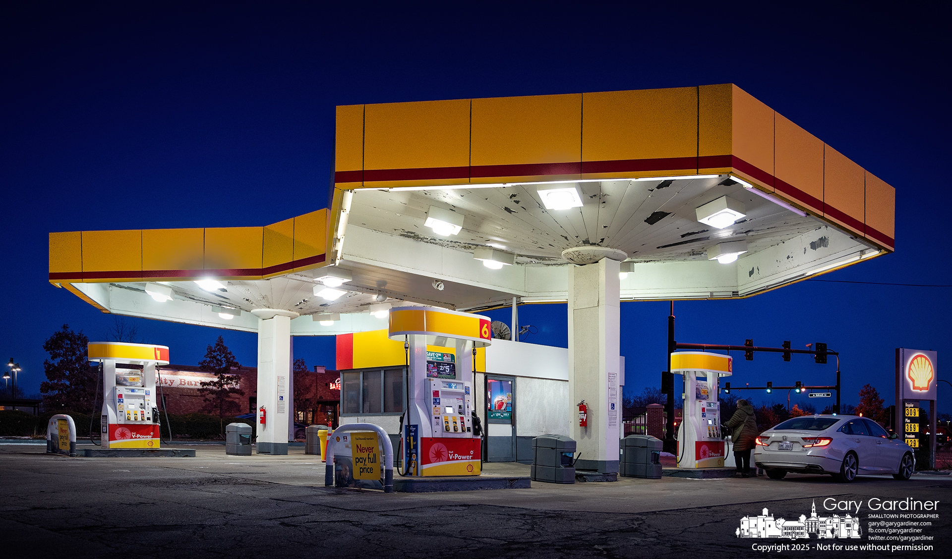 The brightly lit Shell gas station at State and Schrock sits against a clear blue and frigid sky after sunset Tuesday. My Final Photo for January 21, 2025.