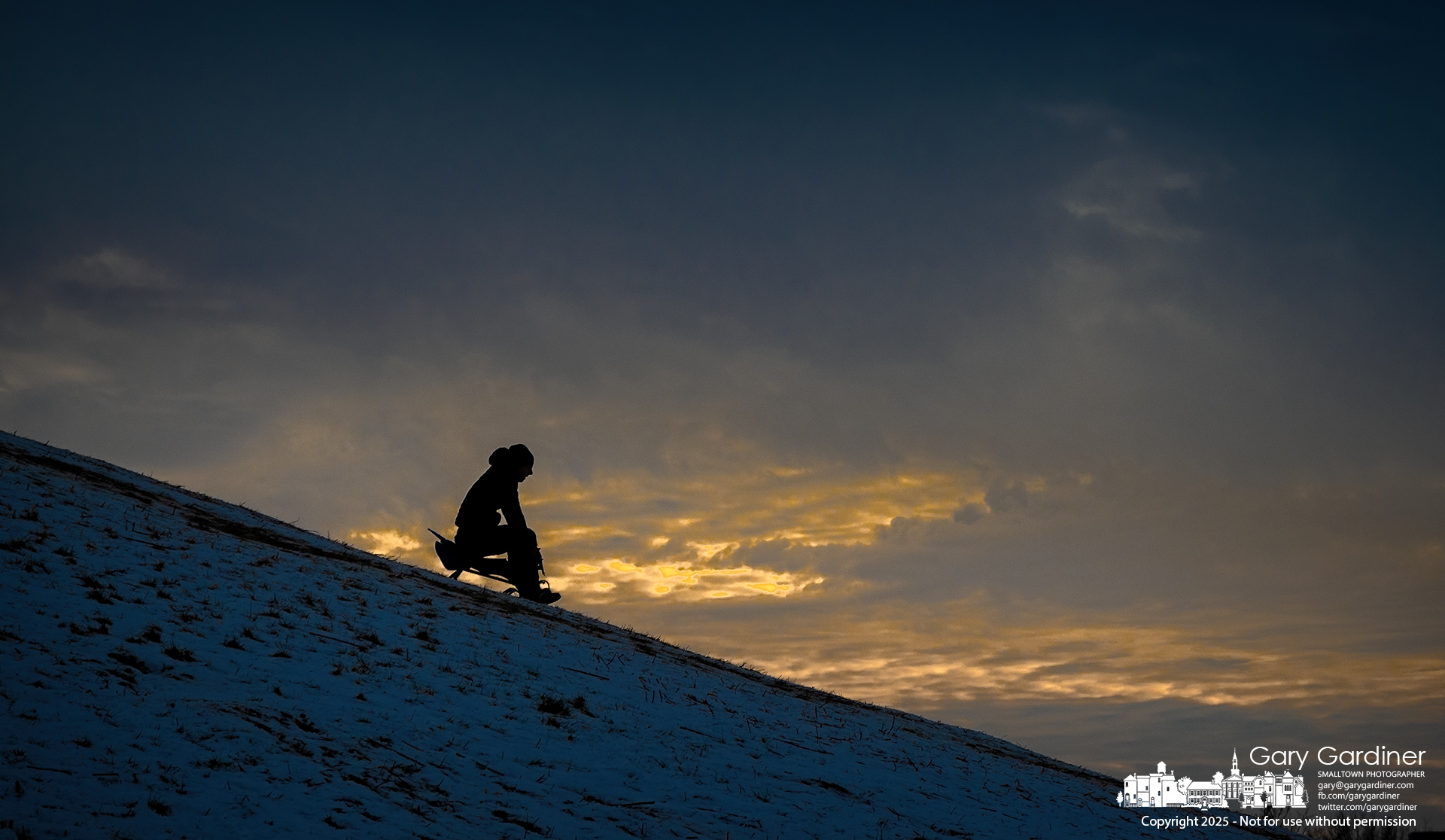 A sledder races down the steep slope at Alum Creek Park South, heading for the icy ramp at the bottom to squeeze in a few runs before sunset on Sunday. My Final Photo for January 12, 2025.