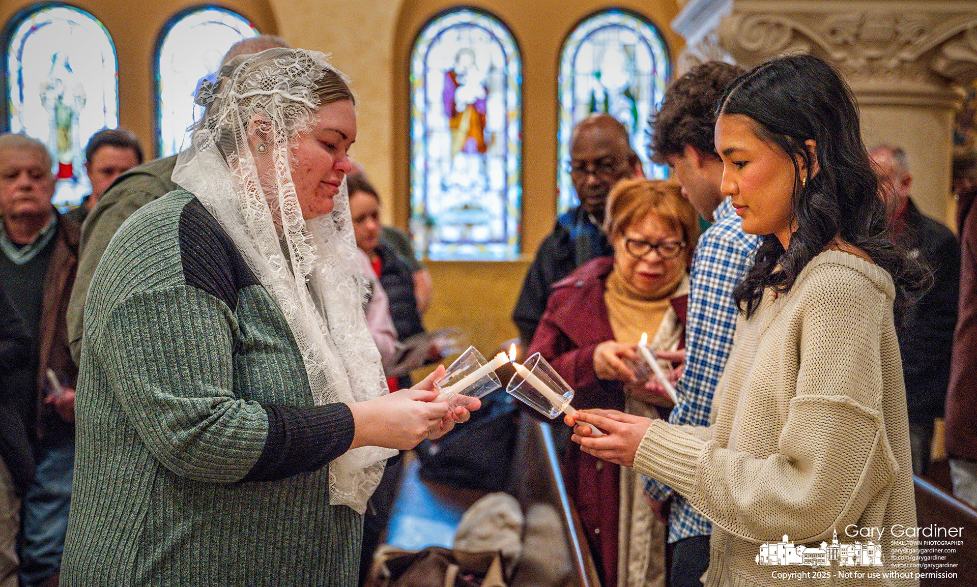 Parishioners light each other's candles as St. Paul the Apostle Catholic Church celebrates Candlemas this Sunday. My Final Photo for February 2, 2025.