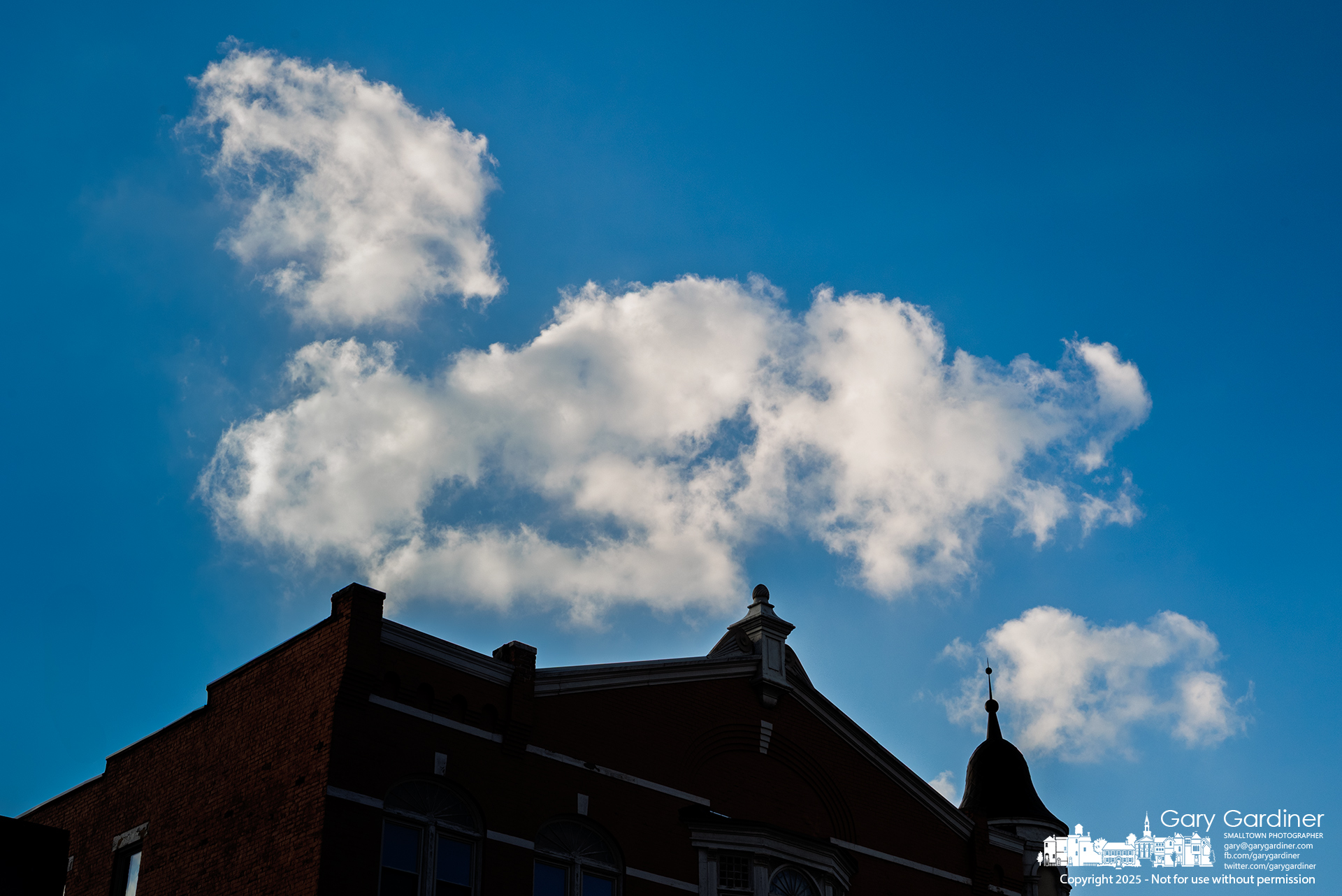 Warm weather, accompanied by light cloud cover, brings welcome relief to Westerville as clouds drift over the Holmes Hotel in Uptown. My Final Photo for February 25, 2025.