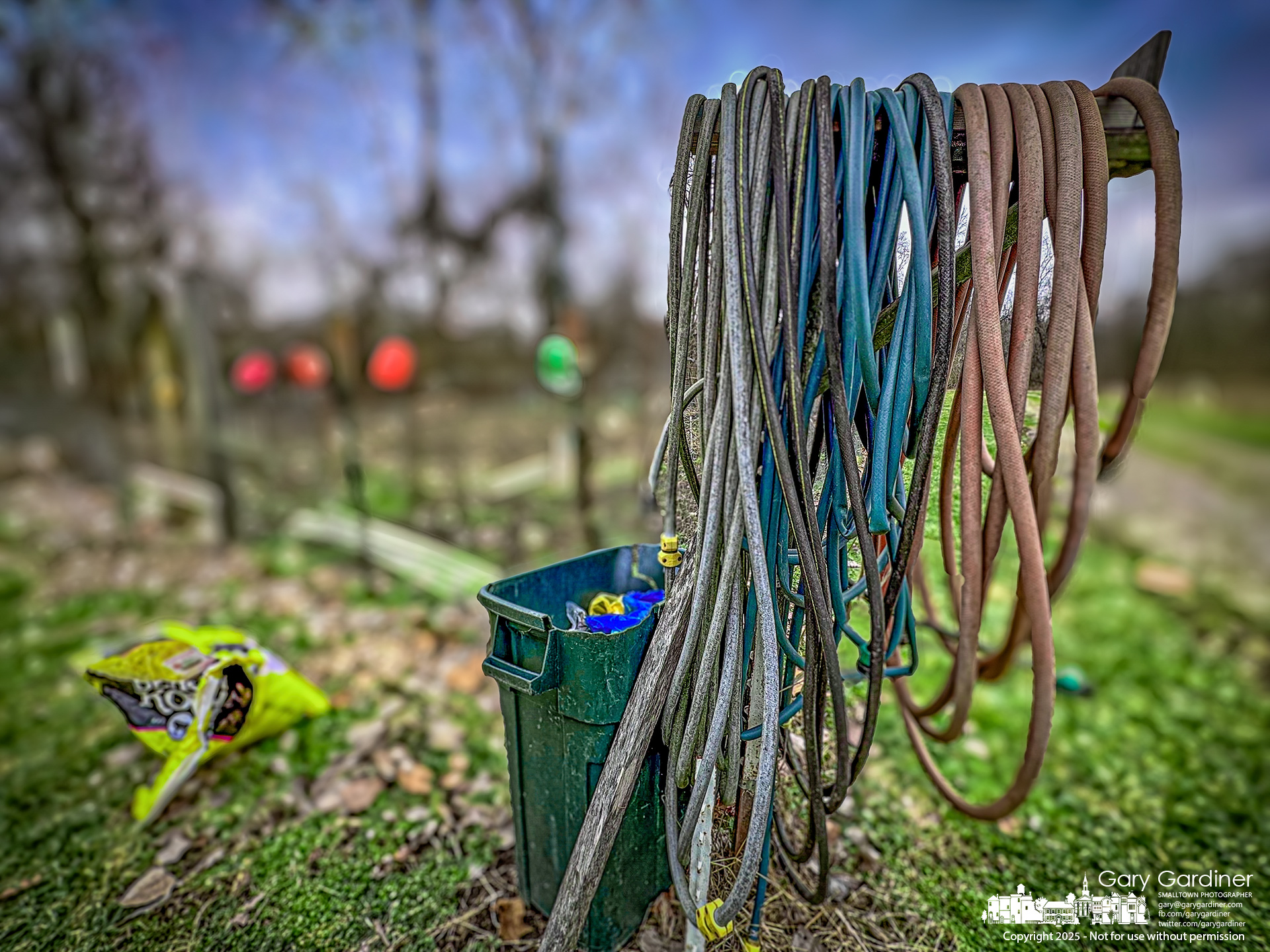 A bundle of hoses hangs from a wooden post and holder at one of the intersections in the Westerville community garden, where a couple of future farmers have already begun to prepare their plots for Spring planting. My Final Photo for February 5, 2025.