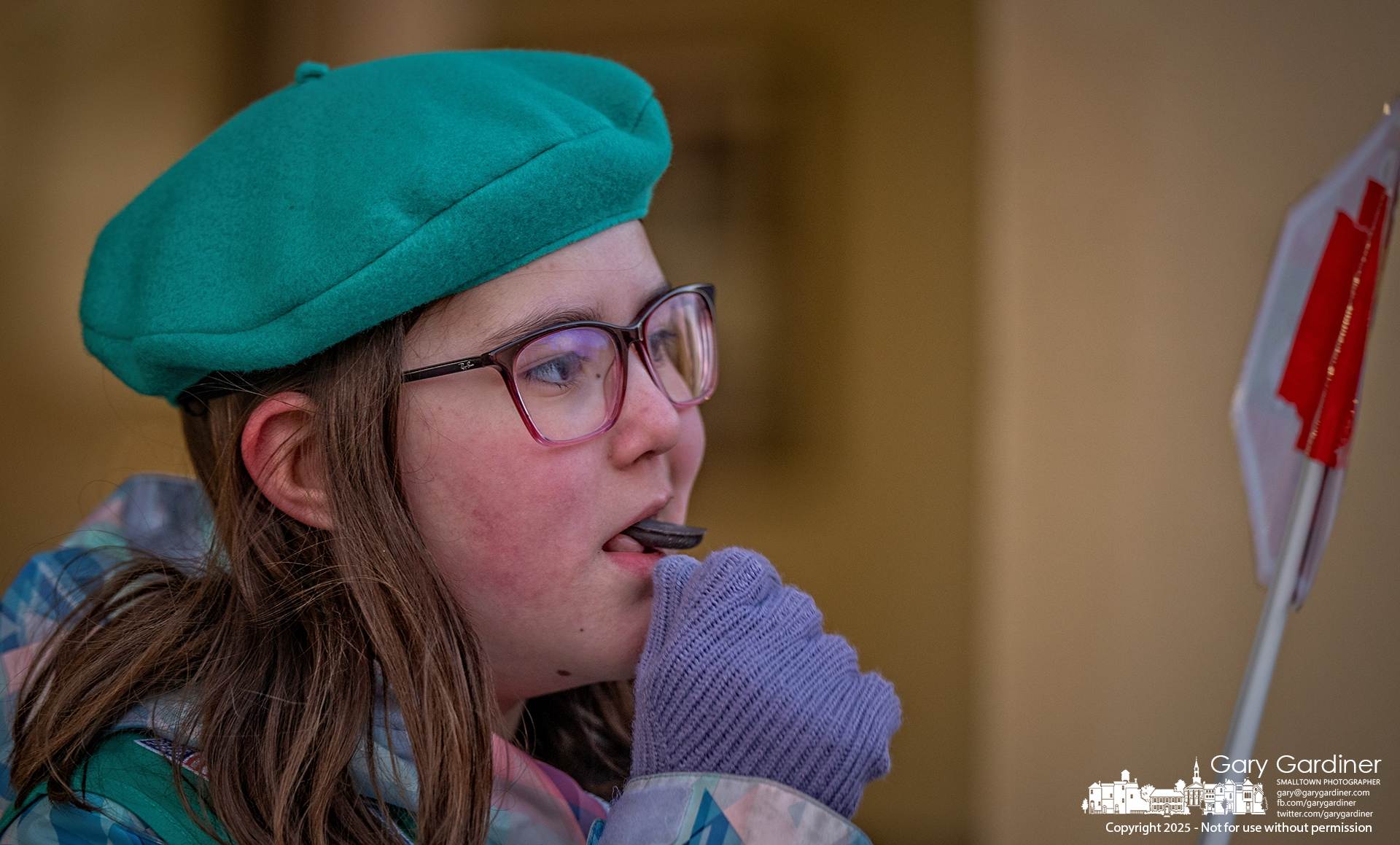 A Girl Scout quickly slips a portion of a Thin Mint cookie into her mouth during a short break from selling the iconic cookies in front of Graeter's in Uptown Westerville Friday. My Final Photo for February 7, 2025.