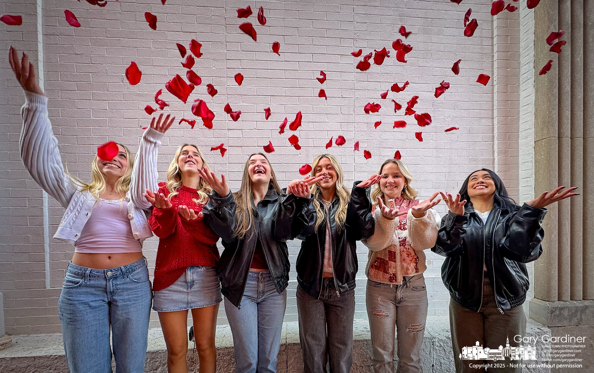 A group of Olentangy High School students, celebrating the birthday of the third student from the left, toss rose petals—a gift from Talbott's Flowers in Uptown—to enhance their special day as they tour Uptown in search of the most photogenic spot. My Final Photo for February 14, 2025.