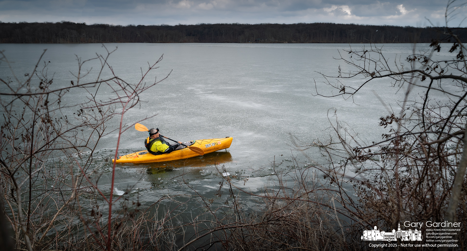 A kayaker battles wind and a thin layer of ice while circling portions of Hoover Reservoir for an afternoon workout. My Final Photo for February 27, 2025.