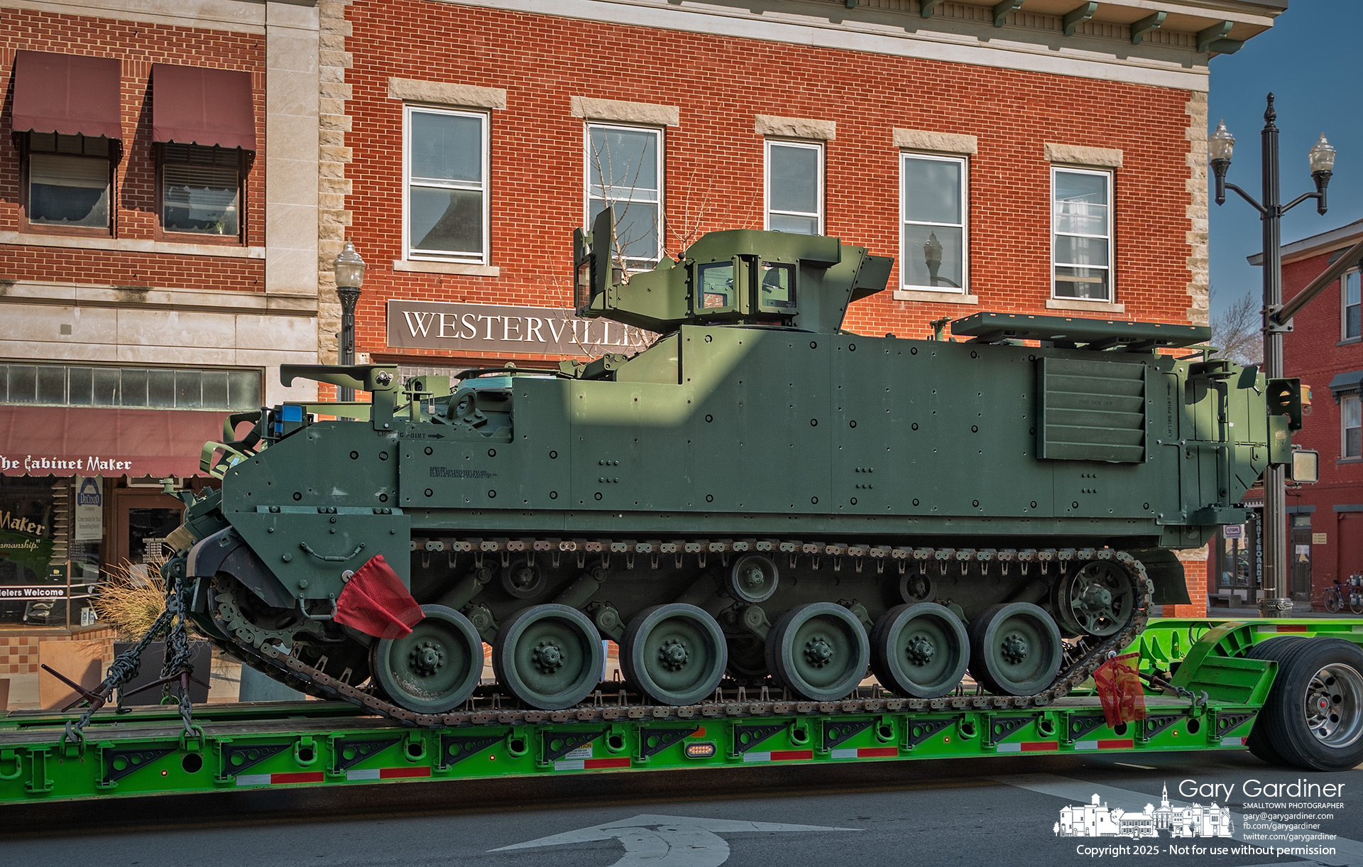 An armored personnel carrier is transported through Uptown Westerville, its destination and mission unknown. My Final Photo for March 12, 2025.