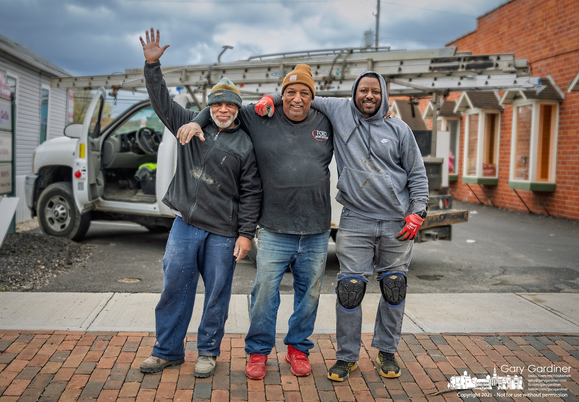 The work crew that patched a section of sidewalk on East College poses for a photo after completing the job. My Final Photo for April 15, 2025.