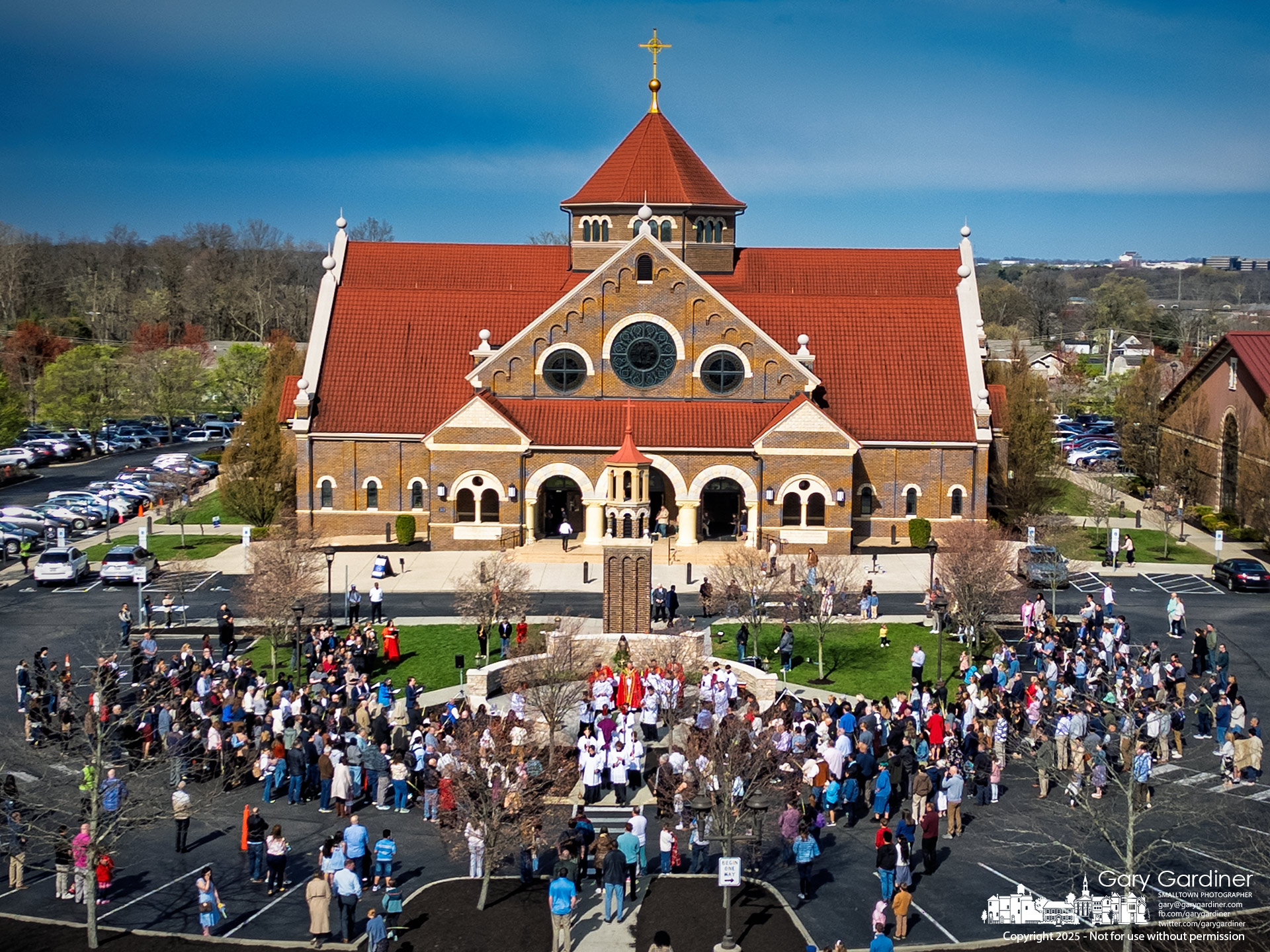 Parishioners at St. Paul the Apostle Catholic Church celebrate the beginning of Palm Sunday Mass with an outdoor scripture reading and procession into the church to complete the service. My Final Photo for April 13, 2025.