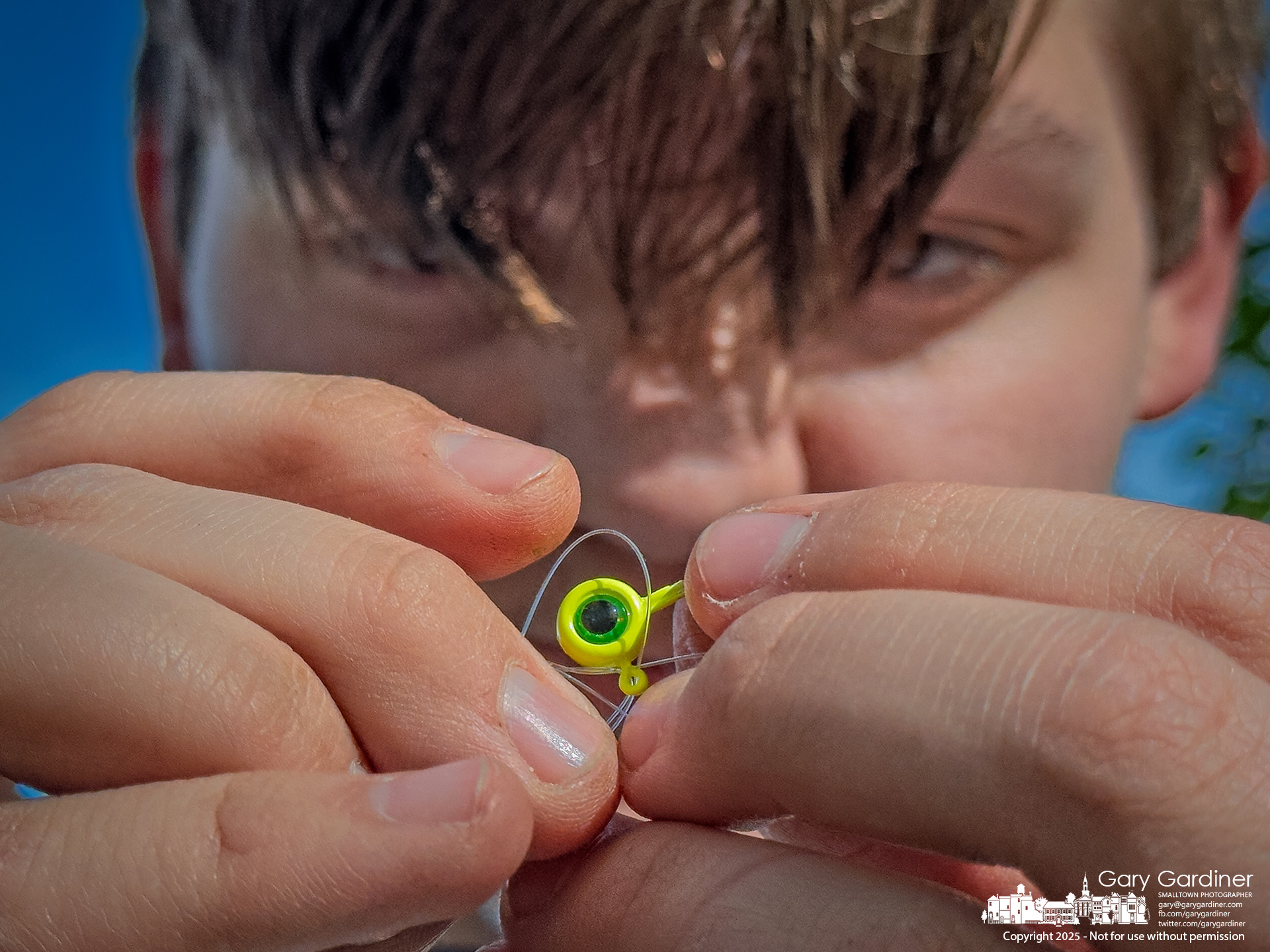 Bishop Merriman watches closely as he ties a lure to his fishing line at the Alum Creek North Park Dam. My Final Photo for May 7, 2025.