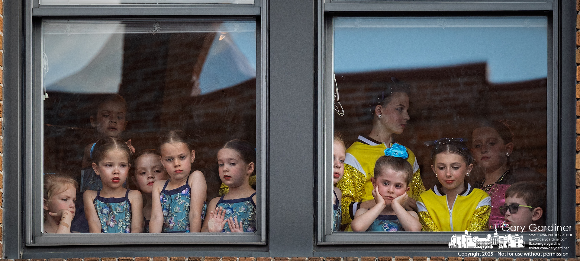 Young dancers watch from the second floor of Generation as older performers take the stage on West College during Fourth Friday in Uptown. My Final Photo for May 23, 2025.