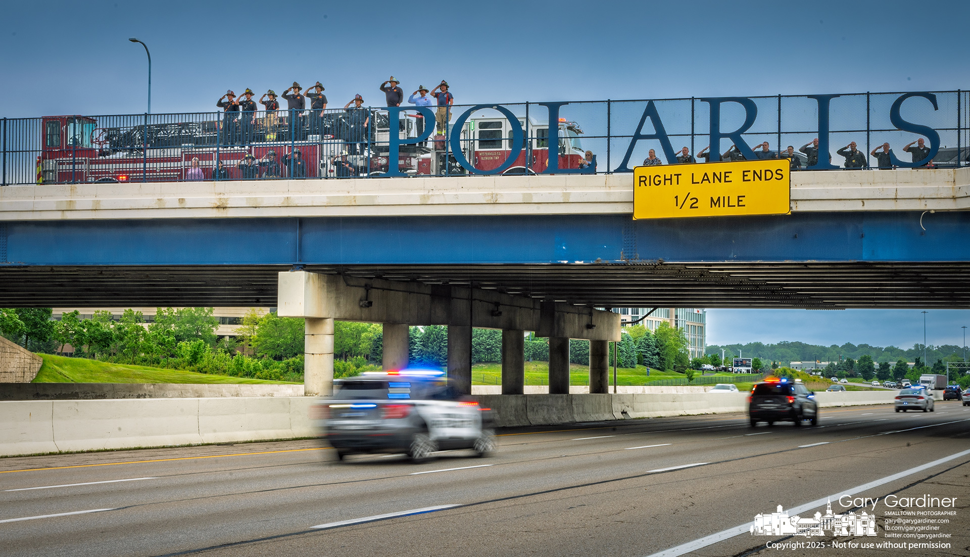 Westerville police officers and firefighters salute from the Polaris Parkway bridge as the procession for Morrow County Sheriff’s Deputy Daniel Weston Sherrer travels to Mt. Gilead. Deputy Sherrer was killed in the line of duty earlier this week. My Final Photo for May 28, 2025.