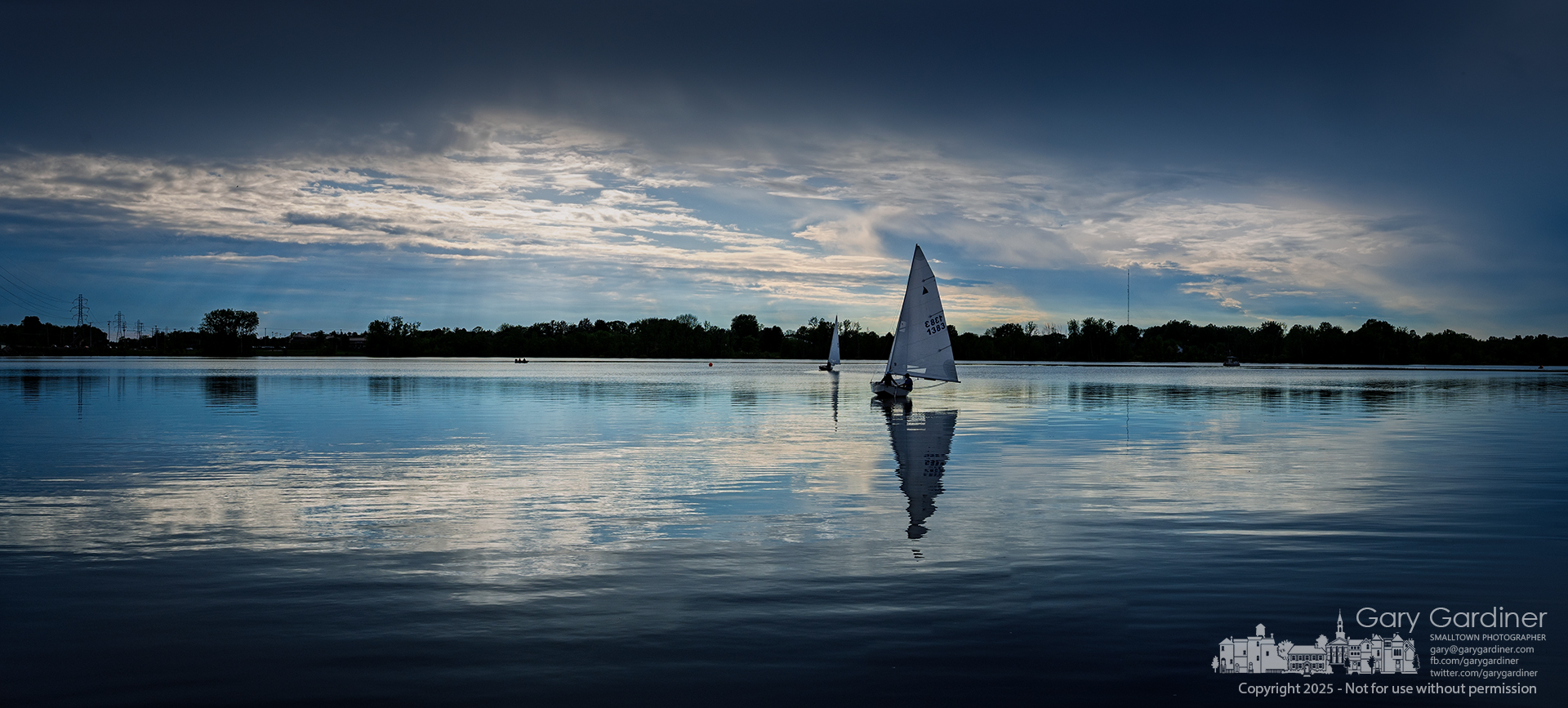 Sailors ease into the wind across Hoover Reservoir as they position for the start of a friendly afternoon race, the near-still waters mirroring the approaching sunset. My Final Photo for May 13, 2025.