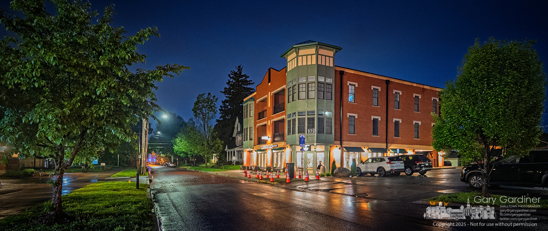 West College takes on a new glow after a day of rain, with the lights from the Ampersand restaurant and the colored lighting on Towers Hall at Otterbein lending a more modern, vibrant look to the brick street. My Final Photo for May 6, 2025.