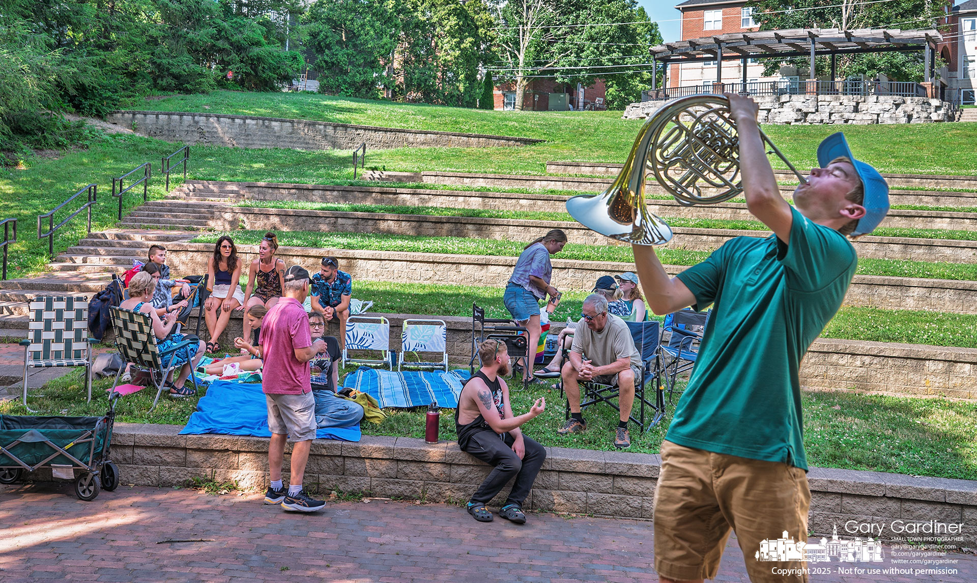 Fifteen-year-old A.J. Dotson played a brief private concert at a nearly empty Alum Creek Park Amphitheater on Sunday night. His family had gathered there for a pizza party to celebrate his birthday following the scheduled performance by the Westerville Jazz Orchestra. When the concert was cancelled due to extreme heat, A.J., a jazz fan who had brought his French horn along, took the opportunity to take the stage himself. My Final Photo for June 22, 2025.