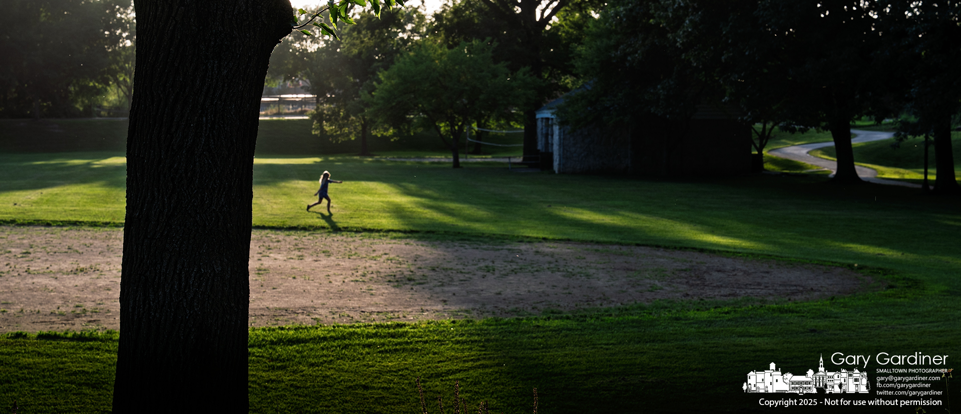 A young girl runs across an open field in the last hour before sunset, heading to the playground at Alum Creek Park North. My Final Photo for June 23, 2025.