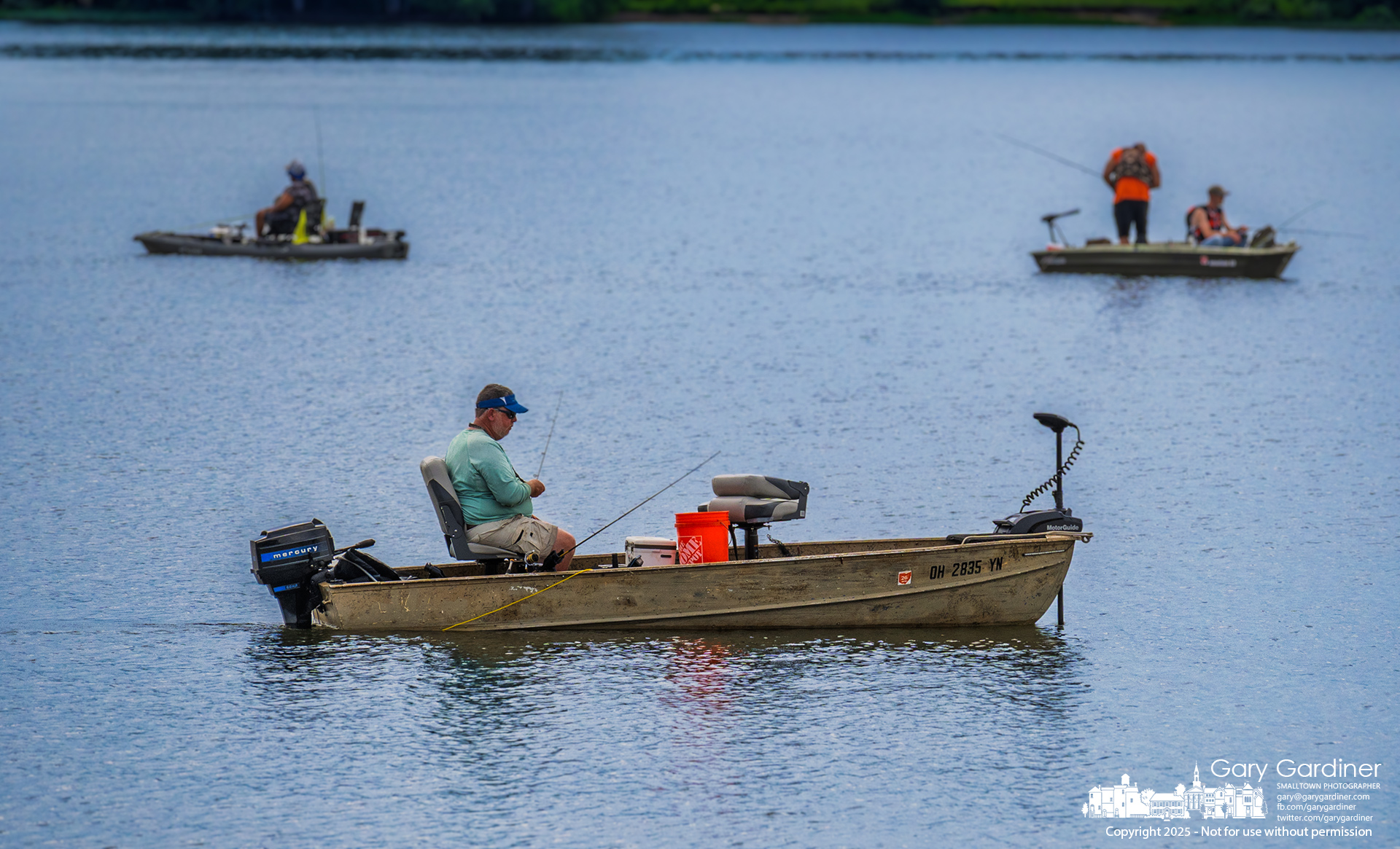 A trolling fisherman passes two others who are anchored and fishing in a small corner of Hoover Reservoir, just above the Smothers Road Bridge and the Hoover Sailing Club. My Final Photo for June 29, 2025.