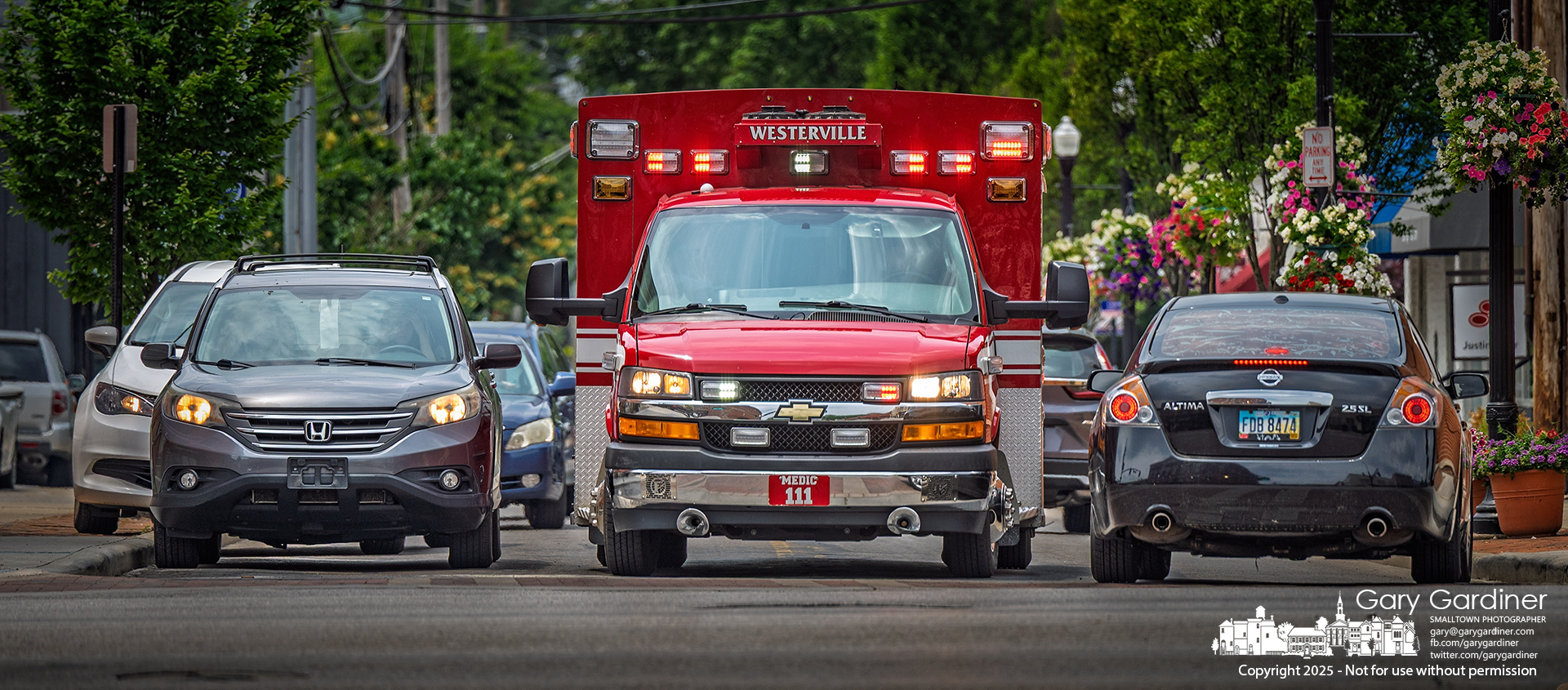 A firefighter struggled Friday afternoon to clear a path for Medic 111 at the intersection of Main Street and State Street during an emergency call. My Final Photo for June 13, 2025.