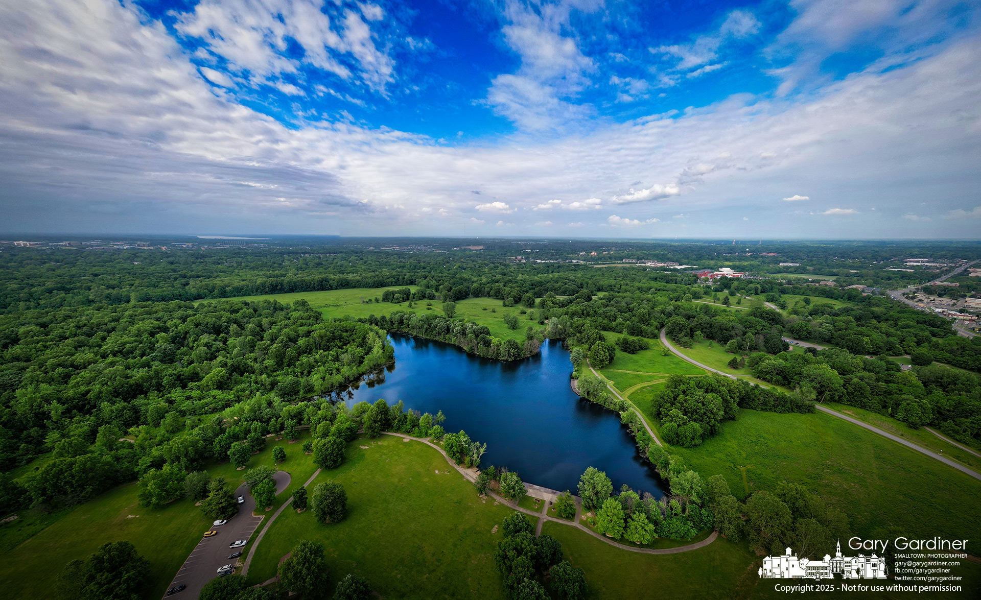 Storm clouds roll in over Schrock Lake at Sharon Woods Metro Park, signaling a shift in the weather as late afternoon sunlight briefly breaks through a thinning patch of sky. My Final Photo for June 5, 2025.