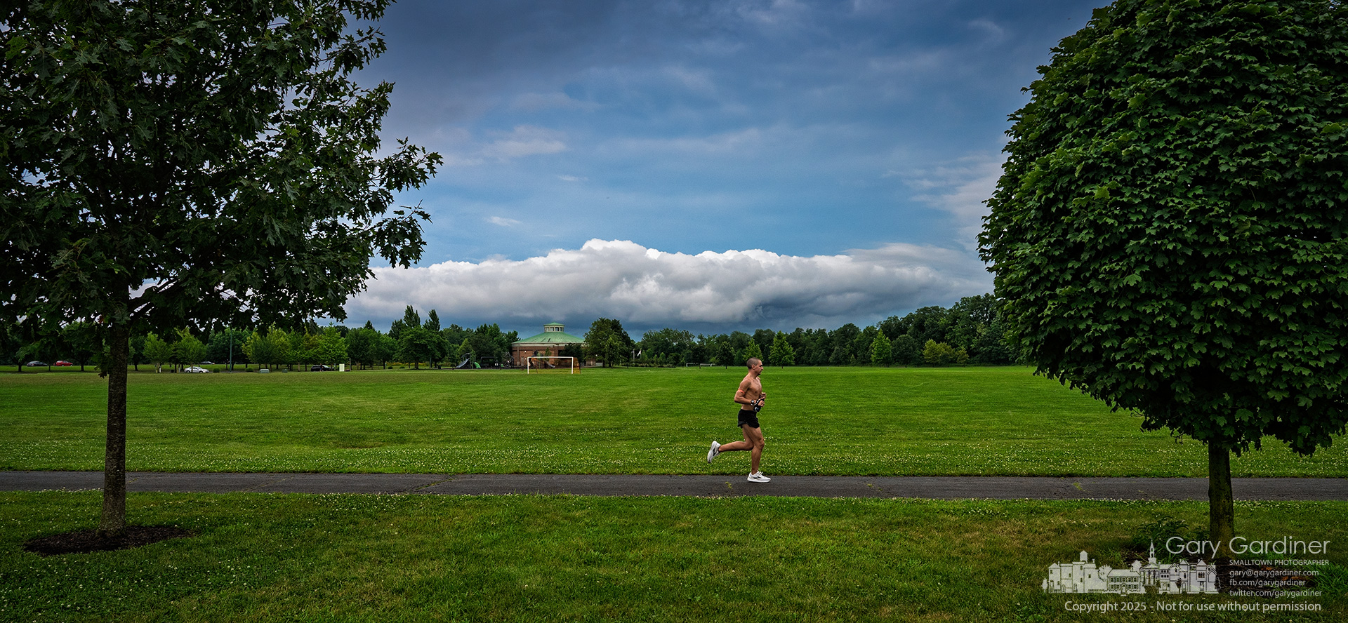 Darkening skies form a dramatic backdrop for a runner at Westerville Sports Fields as afternoon storms threaten the region. My Final Photo for July 27, 2025.