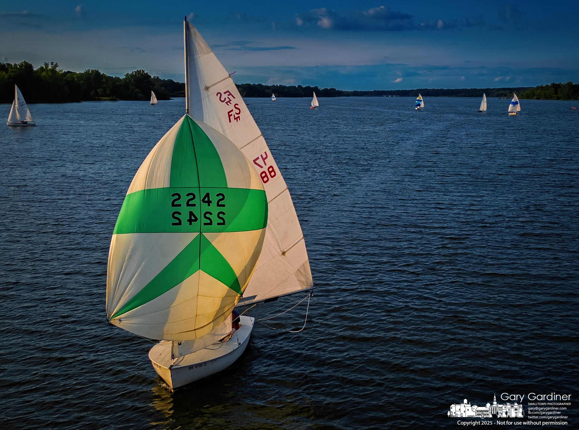 With its spinnaker set, a sailboat leaves a smooth wake as it glides southbound across Hoover Reservoir on Thursday evening. My Final Photo for July 17, 2025.