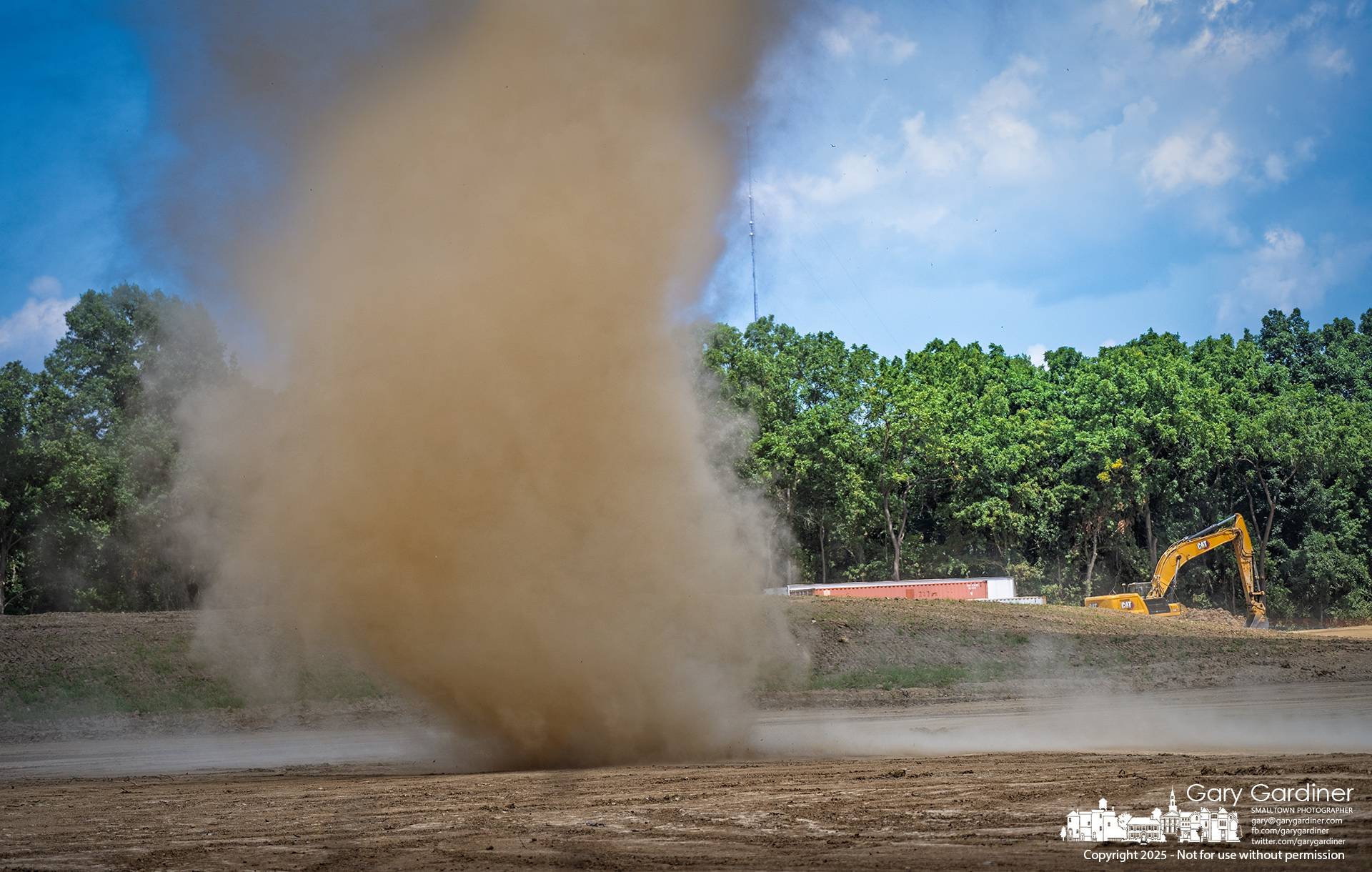 A small dust devil swirls across land behind the Sharp House on Africa Road, where the city is installing infrastructure for potential development of 88 acres of former farmland. My Final Photo for August 11, 2025.