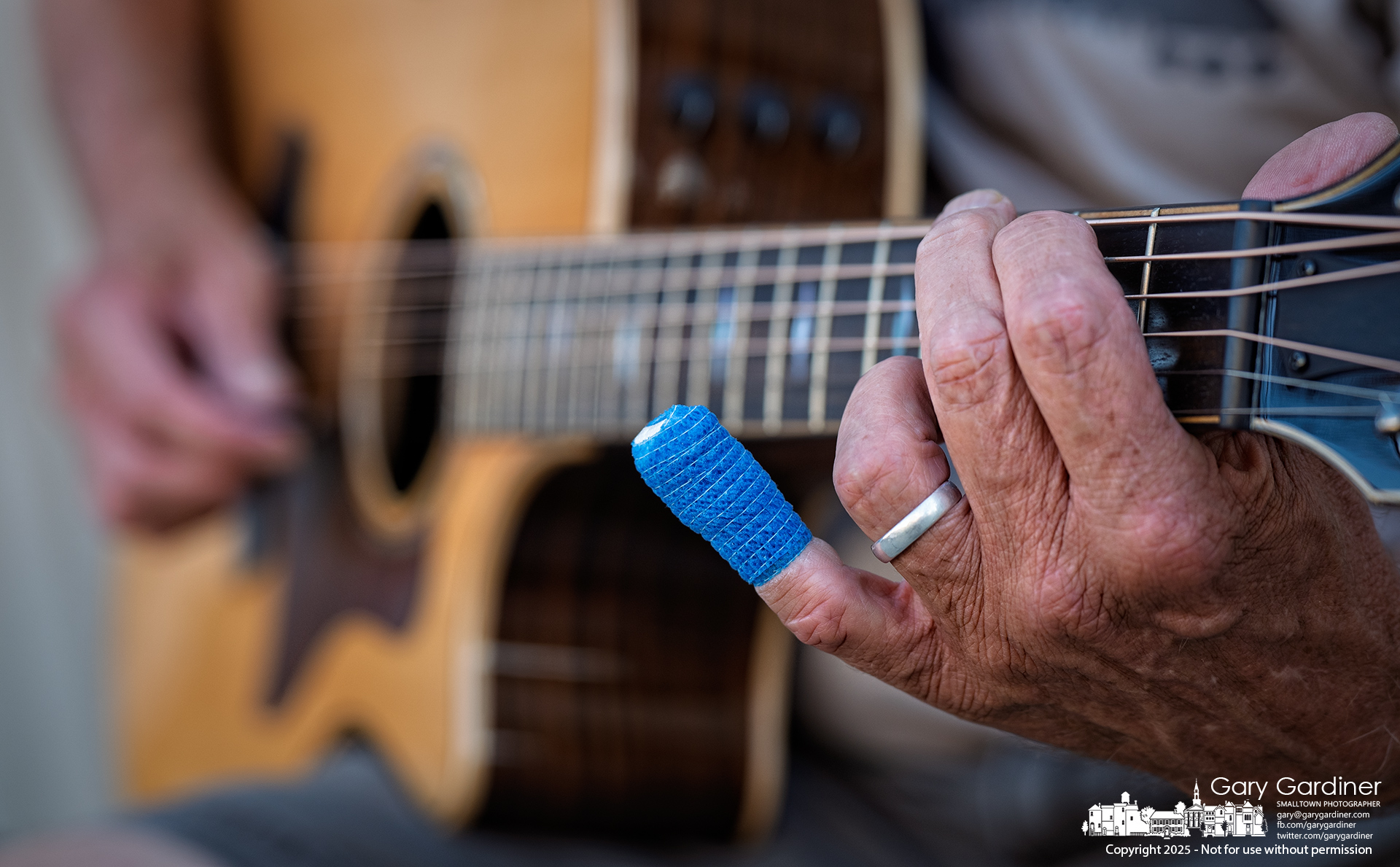 A guitarist performing in a small group in Uptown on Friday night carefully worked the fretboard, avoiding his little finger, which is recovering after its tip was severed in a hedge-clipper accident earlier this week. My Final Photo for August 8, 2025.