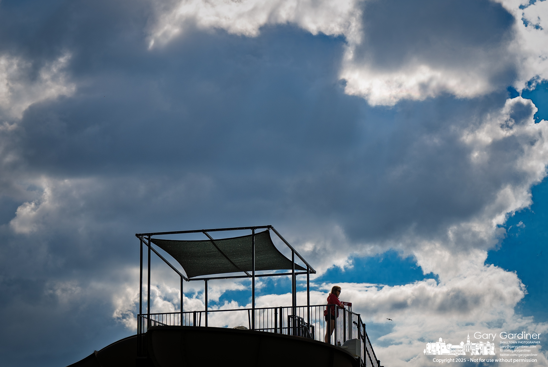 A lifeguard stands watch on the water slide platform at Highlands as a cool afternoon breeze pushes clouds across the Ohio sky. My Final Photo for August 26, 2025.