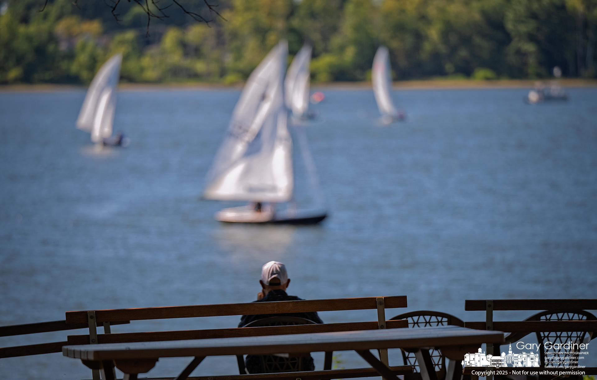 A sailor sits alone at the water’s edge, a gentle breeze brushing past him as he watches other sailors on Hoover Reservoir Sunday afternoon. My Final Photo for August 31, 2025.