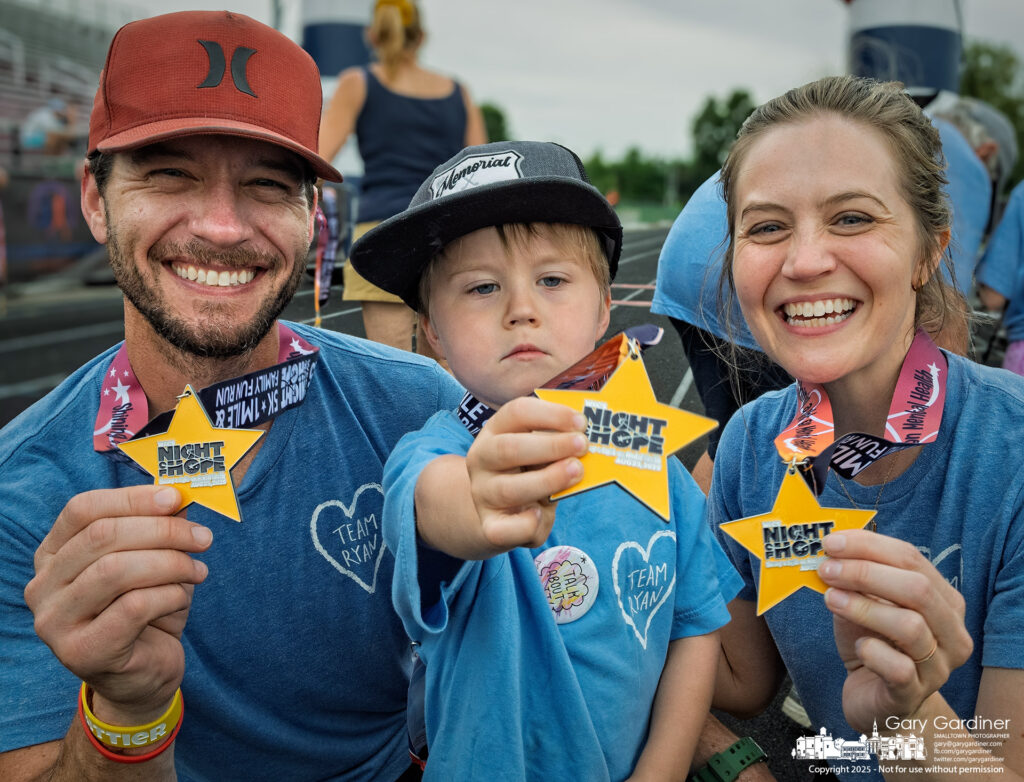 A family displayed their awards for completing the 5K run at Night of Hope, benefiting Westerville Education Challenge's health programs for students. My Final Photo for August 23, 2025.