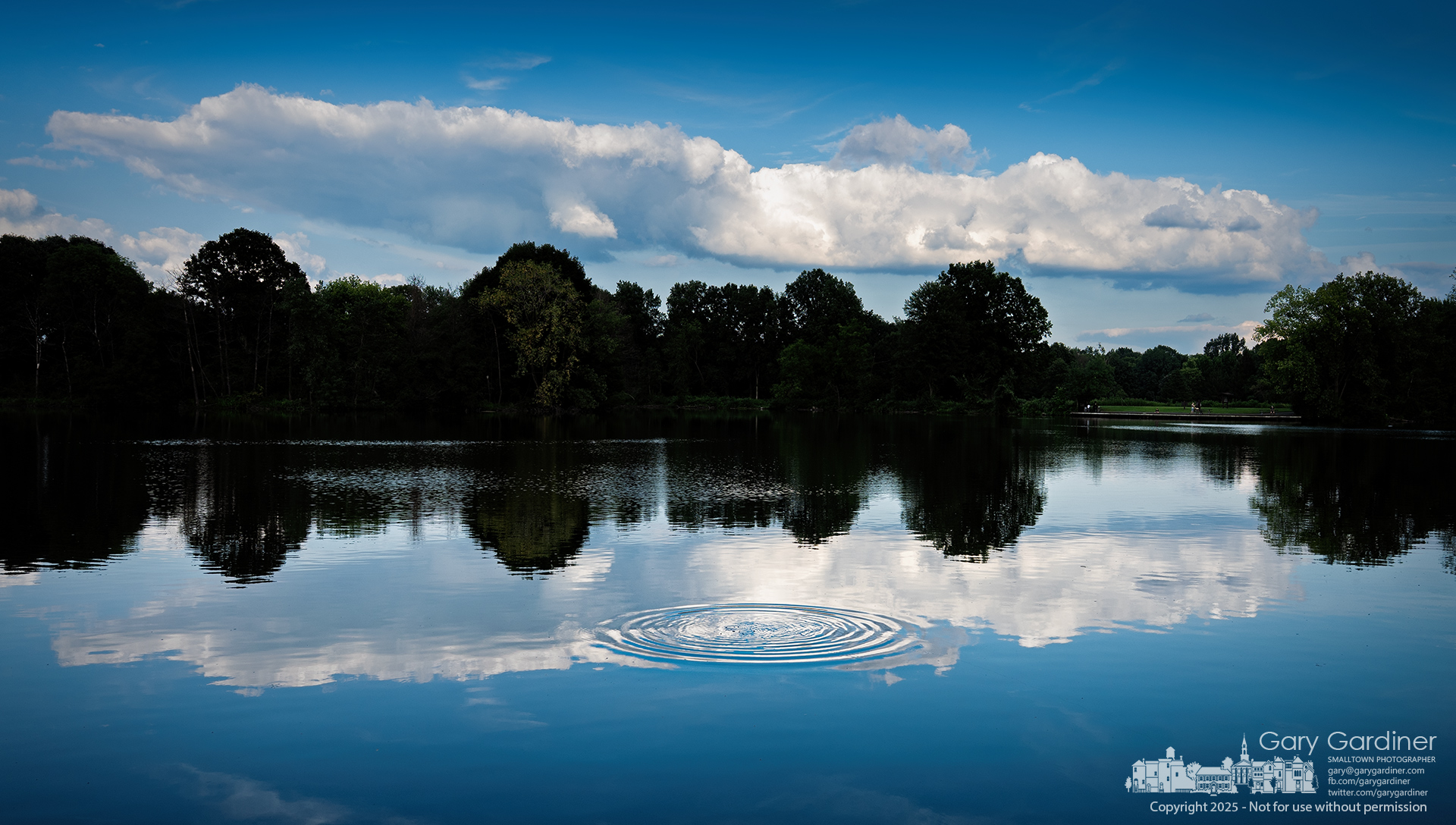 Ripples from a fishing lure spread across the smooth waters of Schrock Lake, breaking the glassy reflection of towering clouds as an angler searches for the perfect catch at Sharon Woods Metro Park. My Final Photo for August 4, 2025.