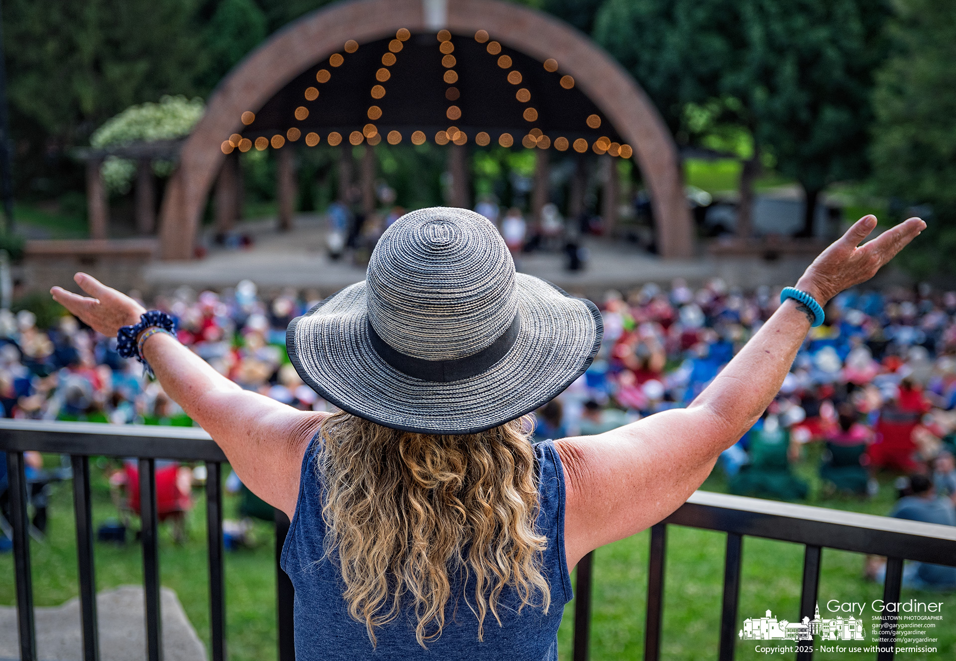 A woman stretches out her arms in celebration during the opening song by Heatwave: The Music of Linda Ronstadt, part of the Summer Concert Series at Alum Creek Amphitheater. My Final Photo for August 10, 2025.