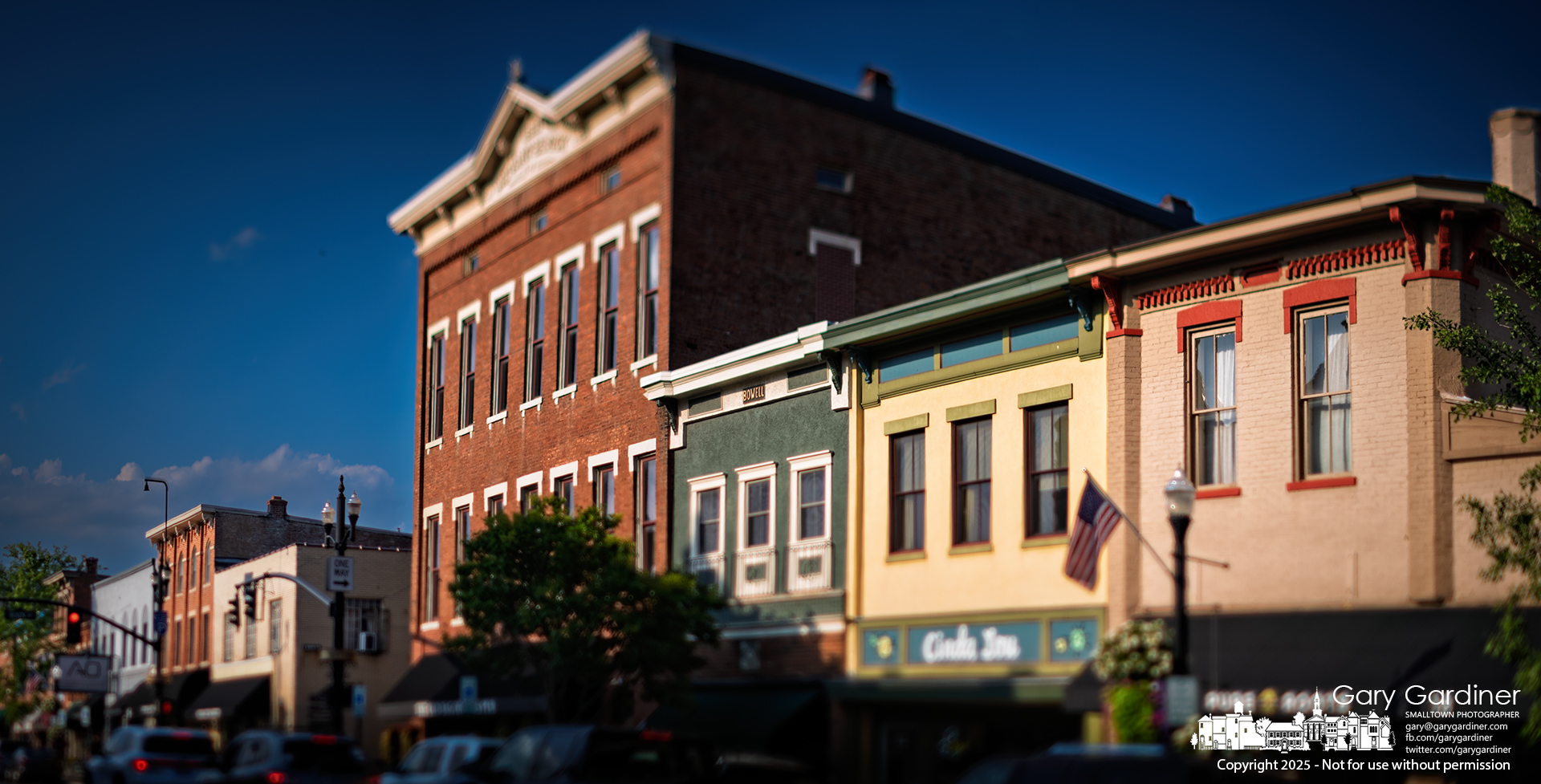 Pedestrian and vehicle traffic continues as the setting sun bathes Uptown Westerville’s central business district. My Final Photo for August 15, 2025.