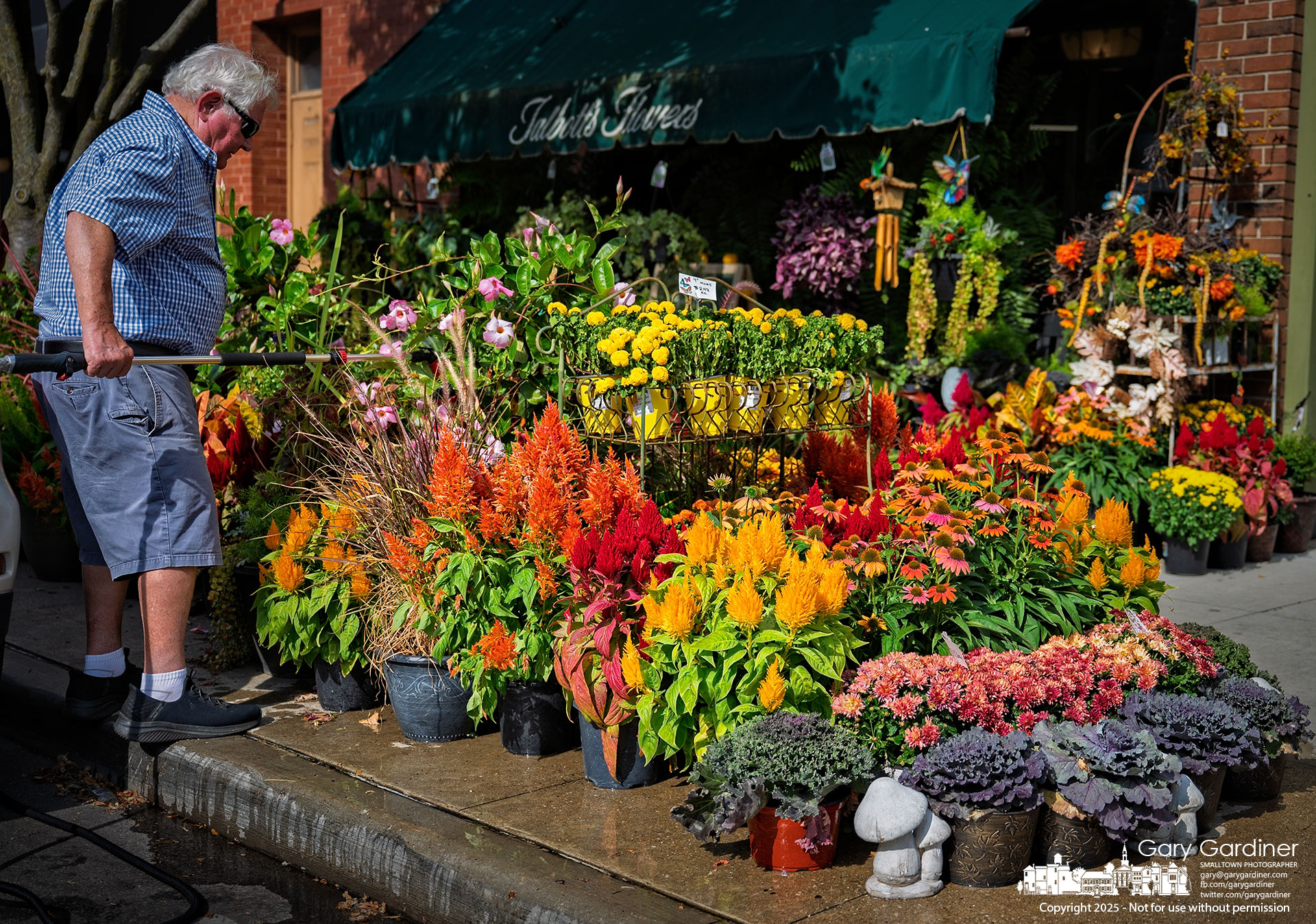 Before calling it a day, florist Dave Talbott waters the flowers lining the sidewalk outside his State Street store in Uptown. My Final Photo for September 16, 2025.
