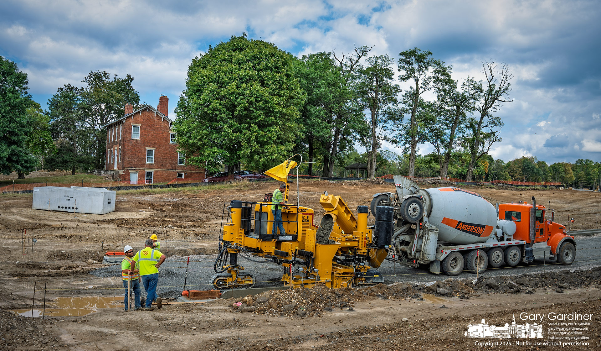 Curbs for the new road passing the historic Sharp House at East of Africa are laid by machine, with construction crews guiding the process. My Final Photo for September 23, 2025.
