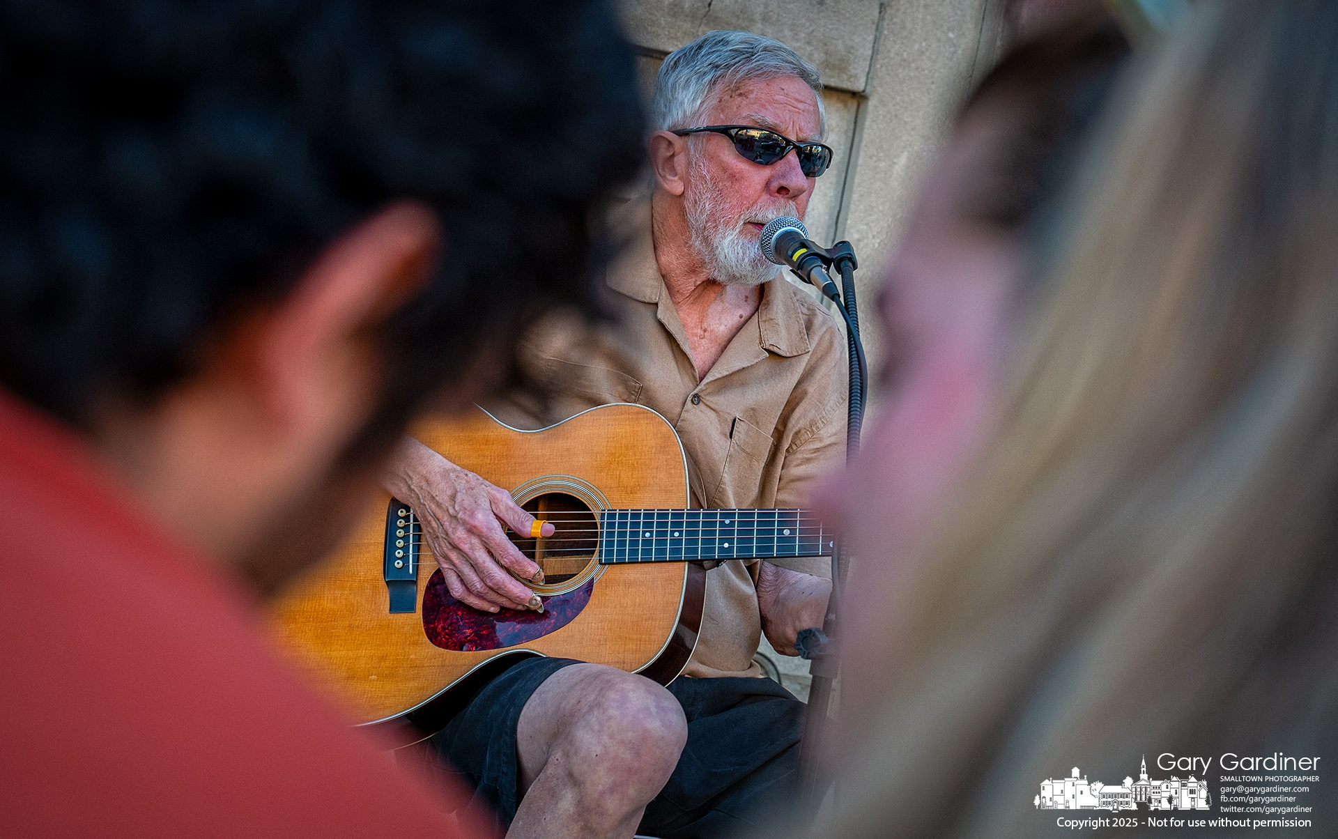 A musician at Uptown Friday Night is framed between a couple sharing a cup of Graeter's ice cream as they discuss the music and savor a nearly perfect early fall evening. My Final Photo for September 12, 2025.