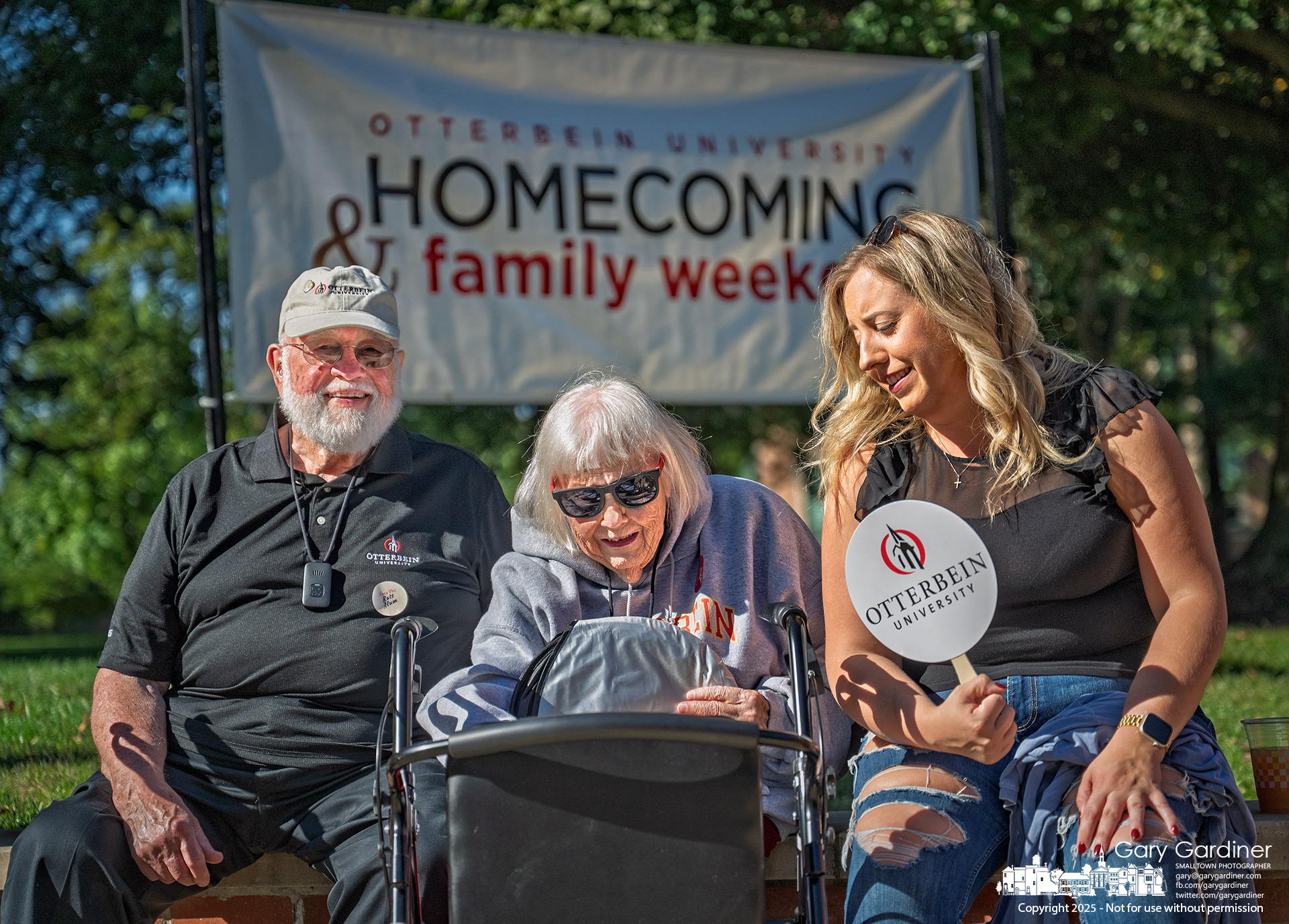 Otterbein graduates Dave Warner, 91 (Class of ’56), and his wife Joyce, 89 (Class of ’58), sit with their granddaughter Stephanie at the corner of Grove and West Main Streets, waiting for the start of the school’s homecoming parade on Saturday. My Final Photo for September 27, 2025.