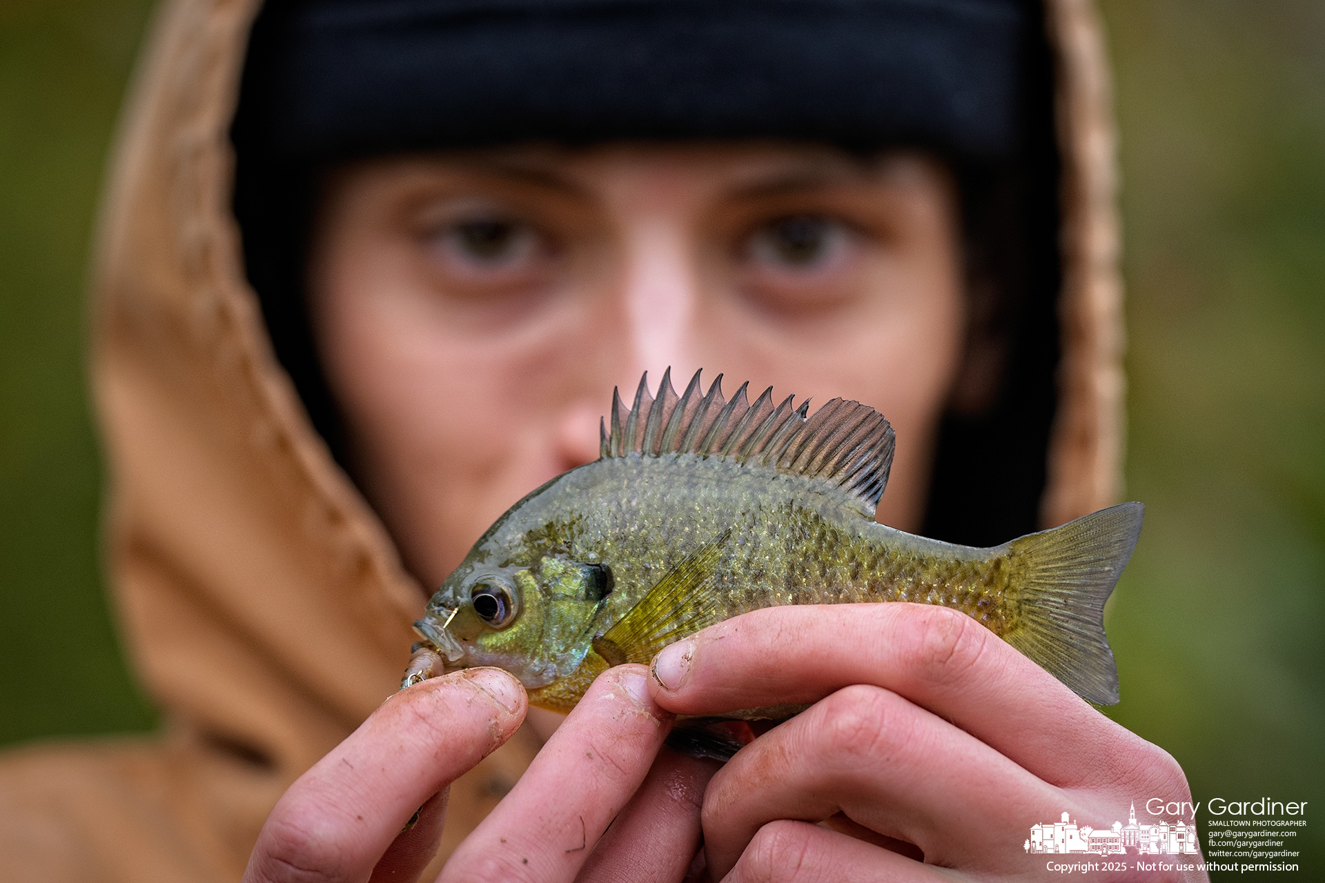 A fisherman reluctantly displays the small bluegill he caught Sunday while hoping for a larger catch at the Alum Creek Park North dam. My Final Photo for October 19, 2025.