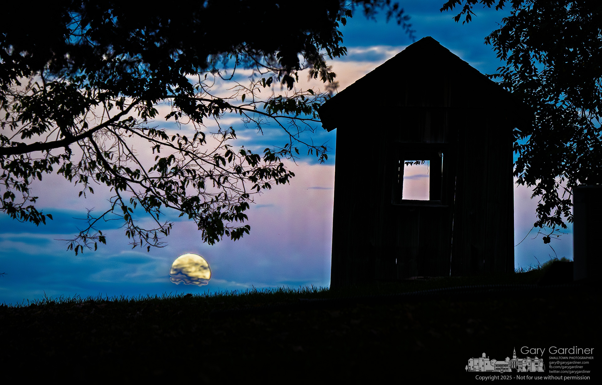 The Harvest Moon rises through low clouds behind the silhouette of a weathered shed near the historic Sharp House on Africa Road. My Final Photo for October 6, 2025.