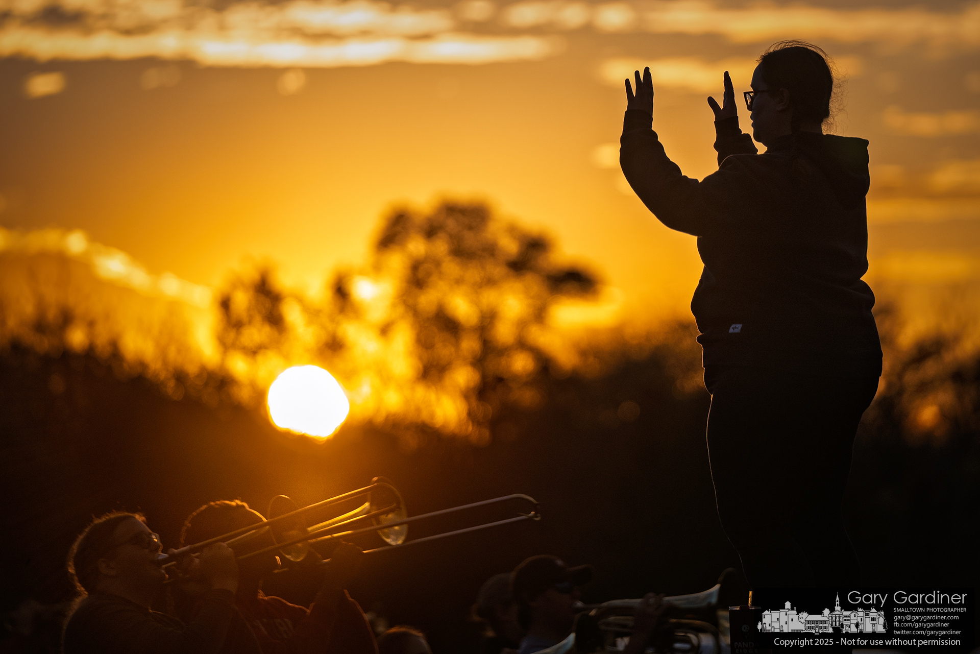As the sun sets behind them, members of the Otterbein Marching Band rehearse on the sports field on North West Street. My Final Photo for November 4, 2025.