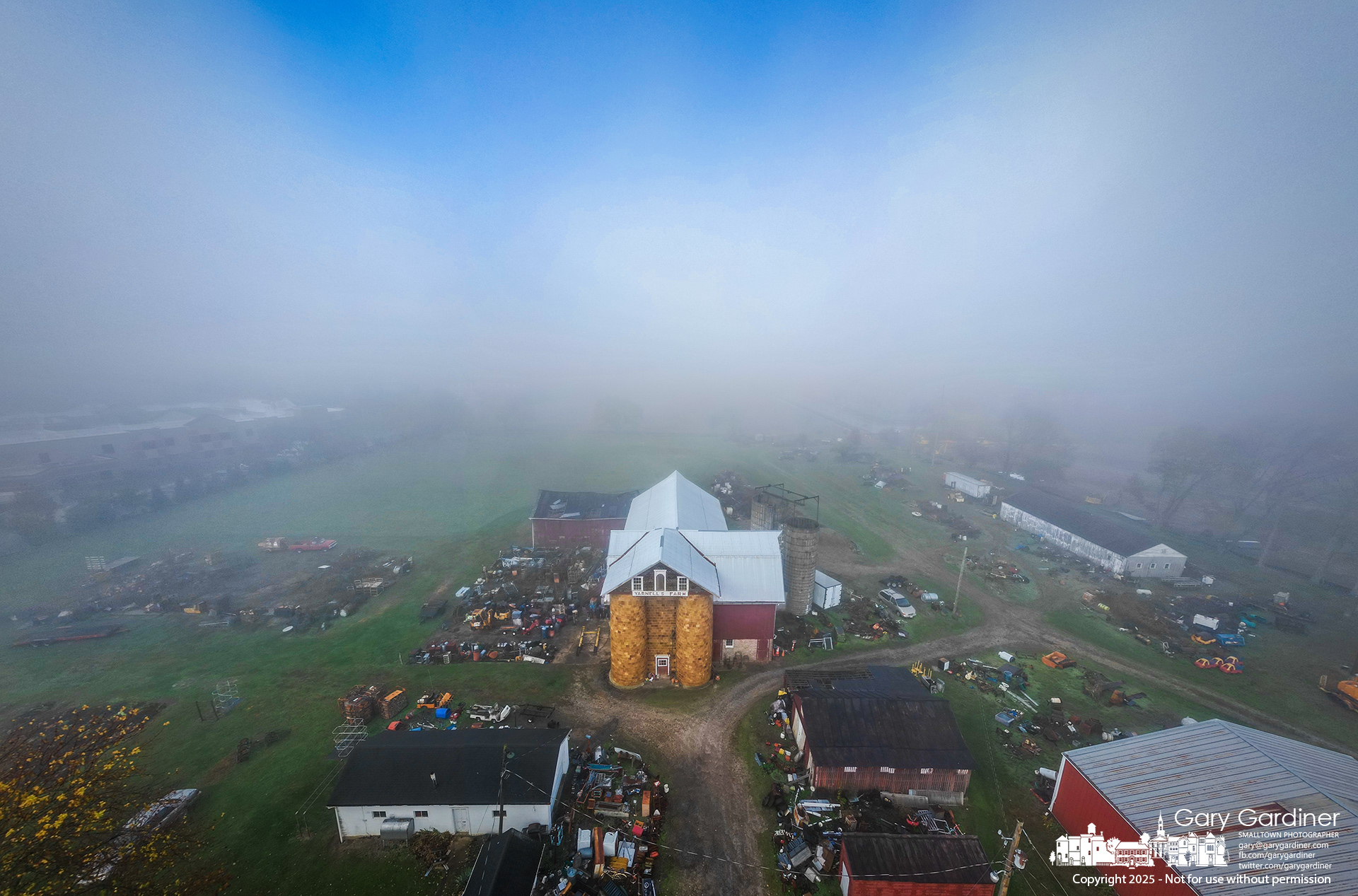 Morning fog rolls across the fields at Yarnell Farm on Africa Road, softening the view of barns, silos, and scattered equipment as the sky begins to clear. My Final Photo for November 8, 2025.