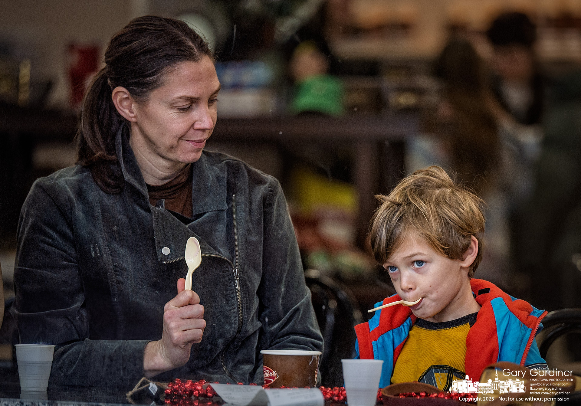 Mom watches as her son playfully finishes their shared bowl of ice cream at Graeter's. My Final Photo for December 27, 2025.
