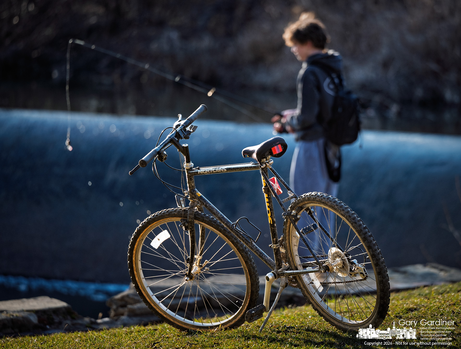 A young fisherman casts into the waters below the Alum Creek Dam, where he rode his bike for a warm afternoon fishing. (My Final Photo for February 27, 2026)