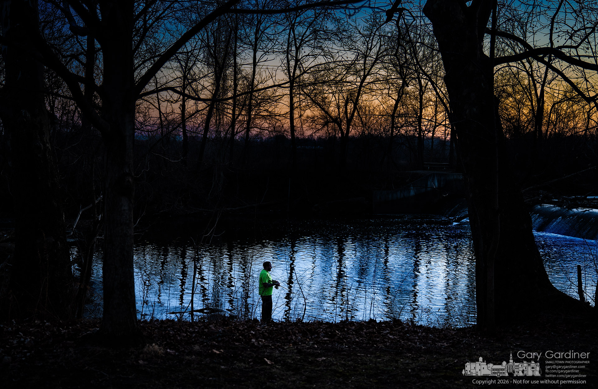 A fisherman settles in for a few final casts as the sun sets beyond the shallopws at Alum Creek Park North dam. (My Final Photo for February 18, 2026)
