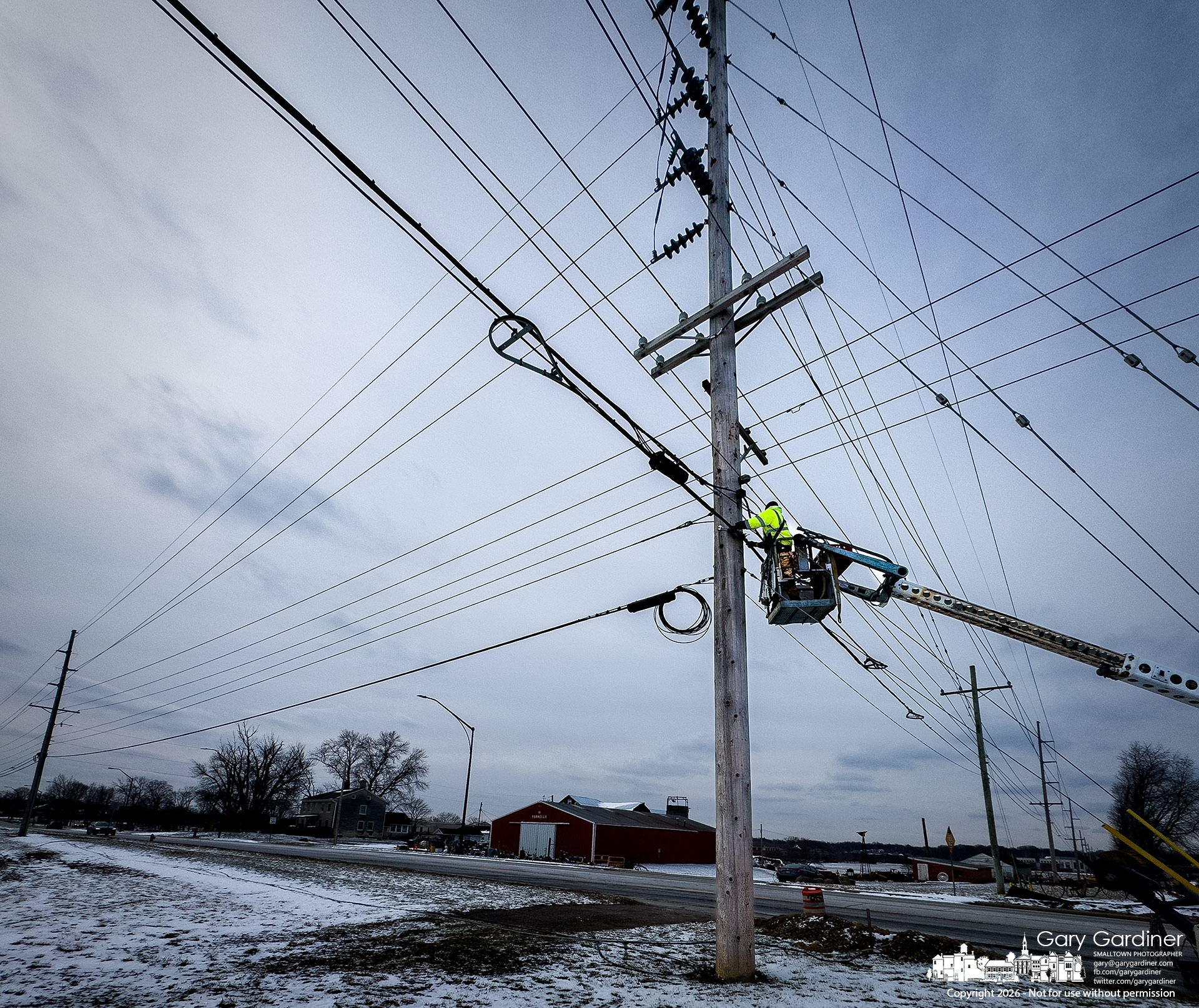 A linesman removes a data cable from a utility pole on Africa Road as the city prepares to move the East of Africa electrical supply underground. (My Final Photo for February 24, 2026)