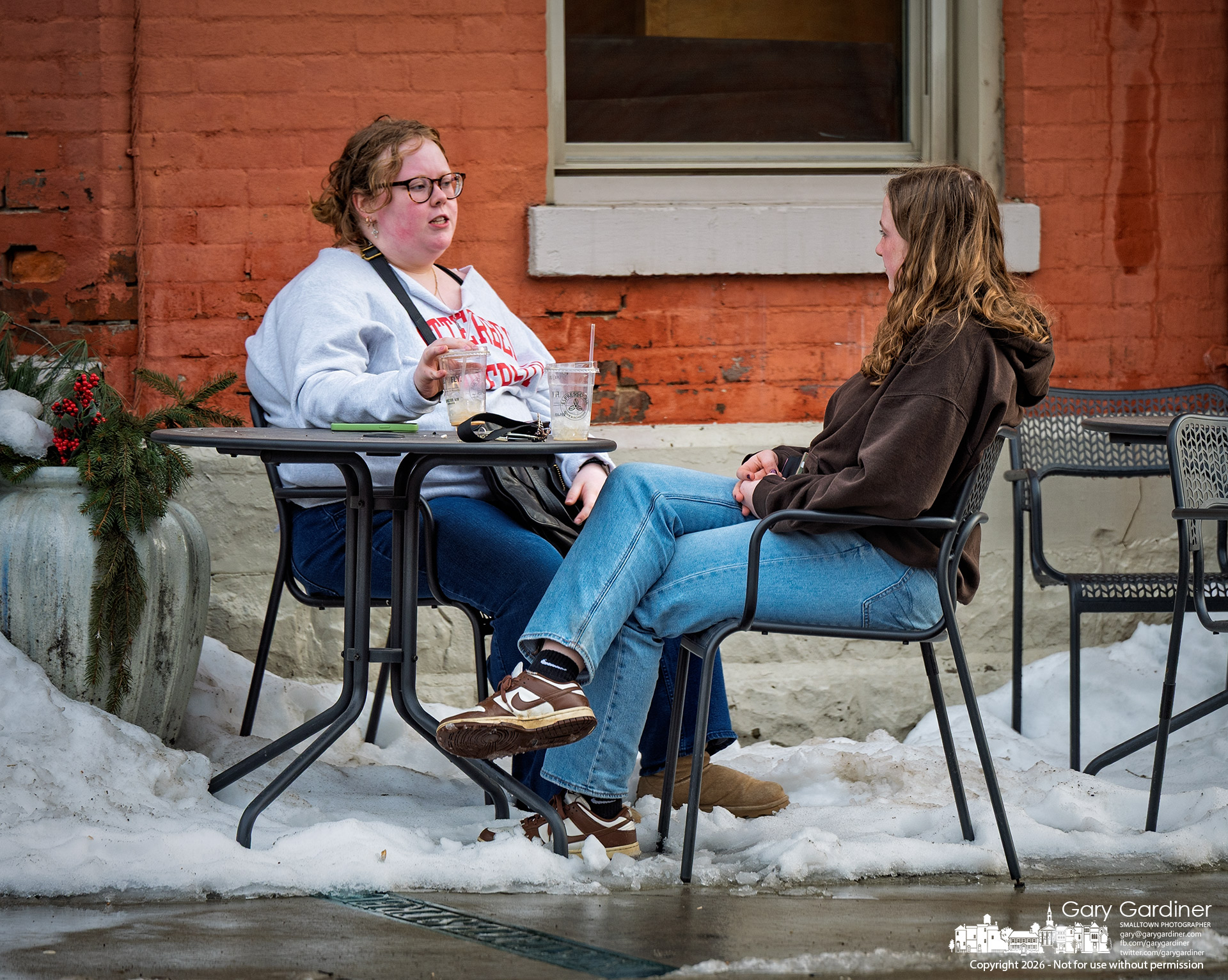 A stretch of warmer weather reopened Espresso Cafe's sidewalk patio, with leftover snow serving as a reminder that spring was still early. (My Final Photo for February 10, 2026)