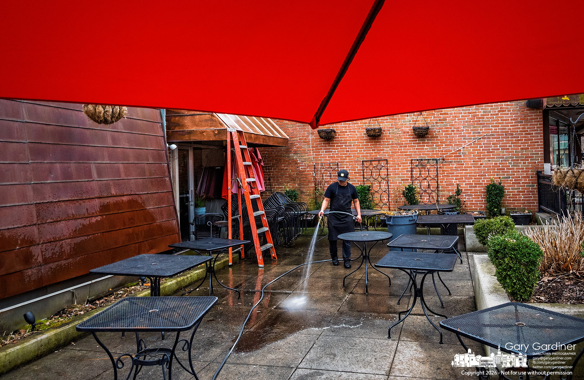 The patio at Jimmy V's in Uptown gets a thorough washing on Thursday, removing the winter crud as it prepares for business as the weather warms. (My Final Photo for February 19, 2026)