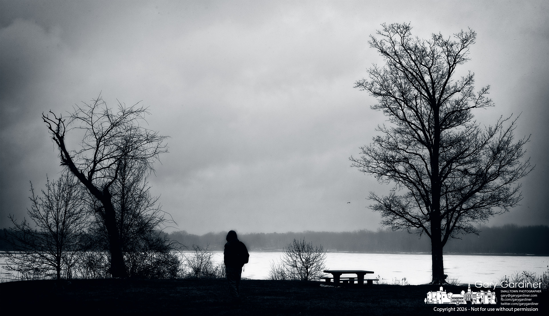 A man walks his dog across the wet grounds of Red Bank Park during an afternoon snow squall. (My Final Photo for February 22, 2026)