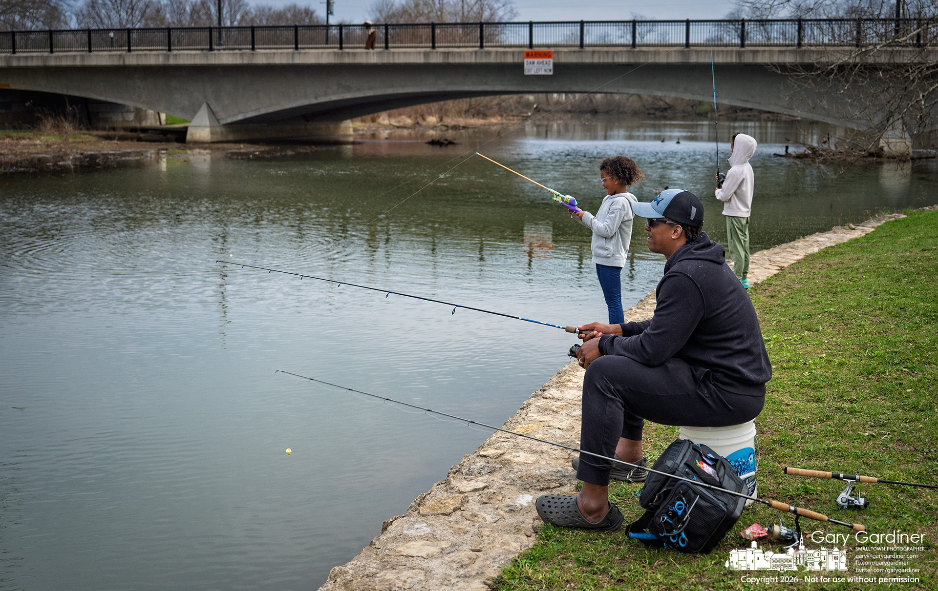 Father and sons fish along Alum Creek just above the Main Street Bridge on the first day of Spring. (My Final Photo for March 20, 2026)