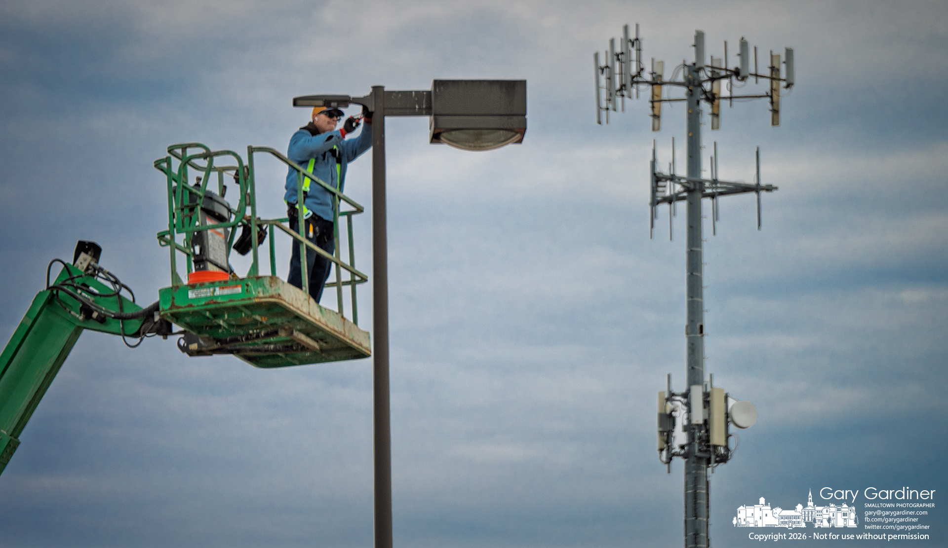 An electrician repairs a parking lot light at Home Depot on Maxtown after the storm Friday left a significant portion of the city without power. (My Final Photo for March 14, 2026)